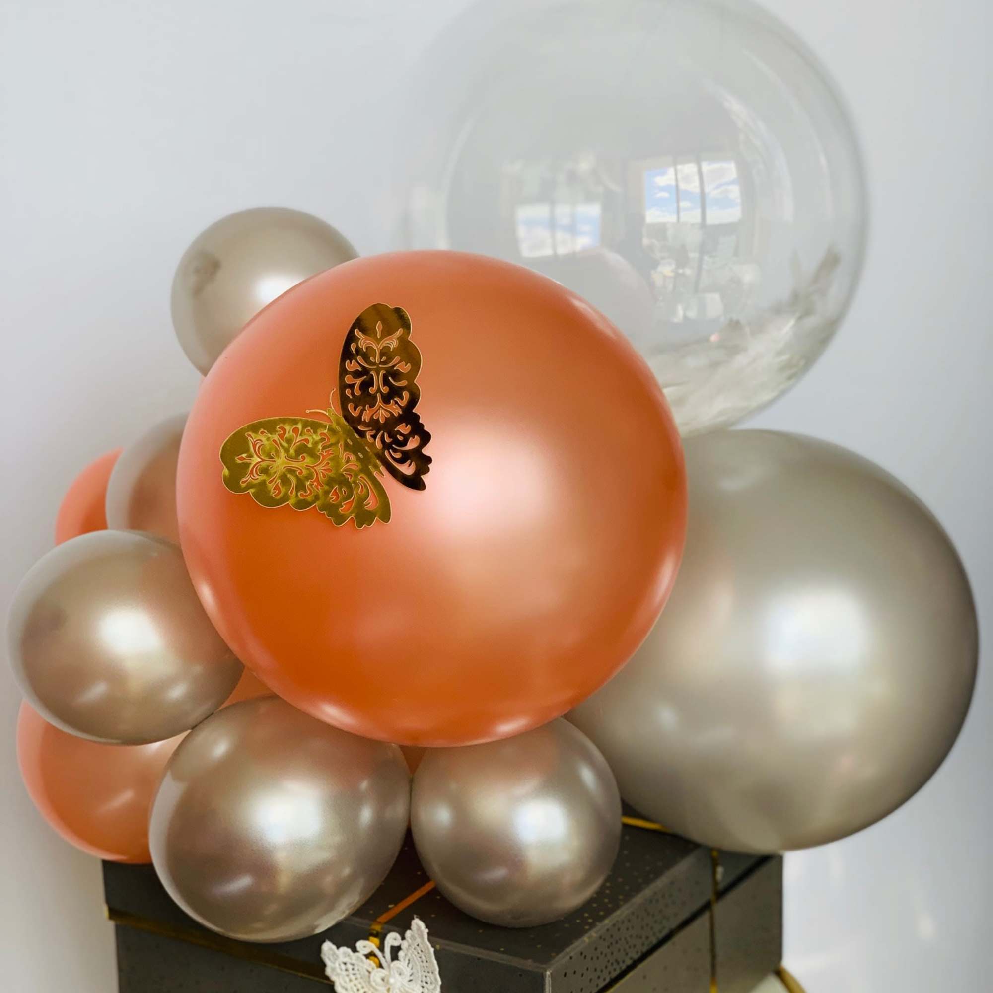 A Godiva chocolate gift box warped with the ribbon and crowned with