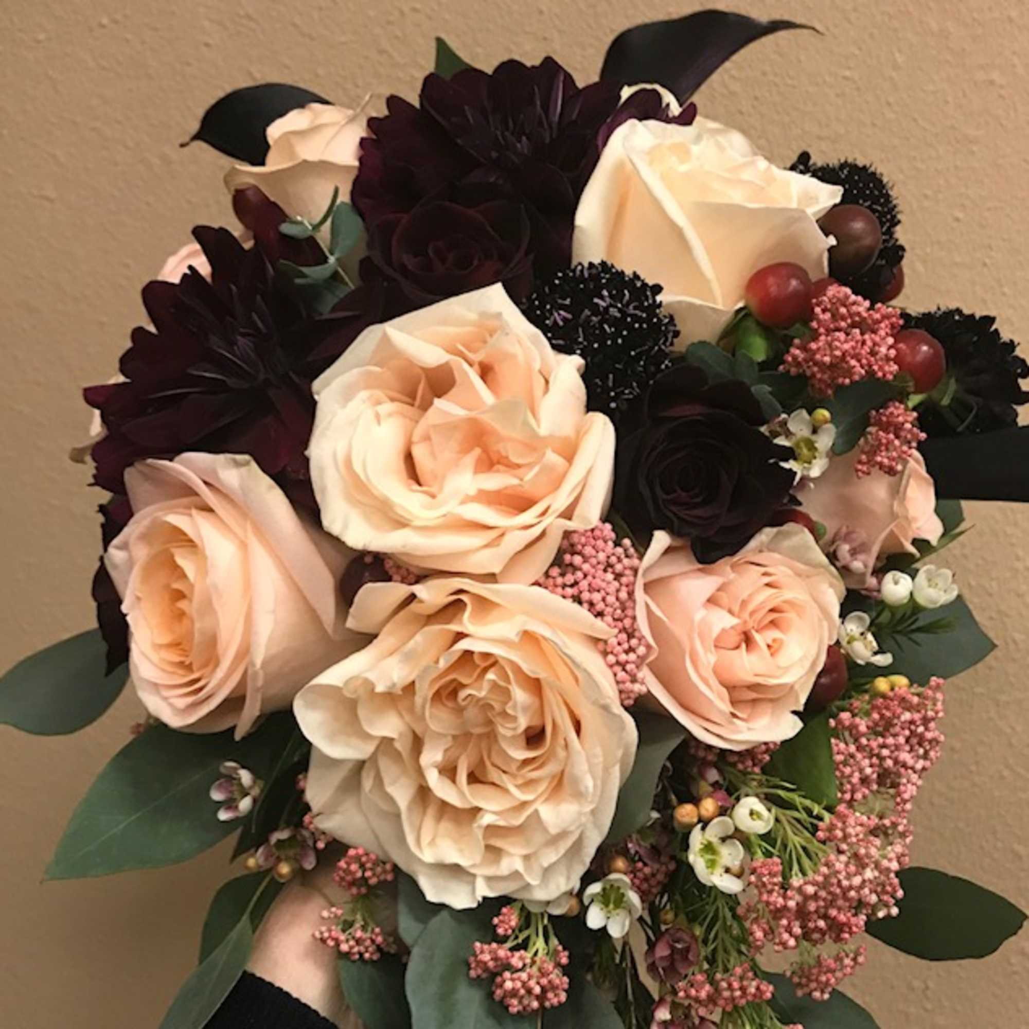 Burgundy dahlias, black mini calla lilies, peach garden roses, blush roses, cosmo