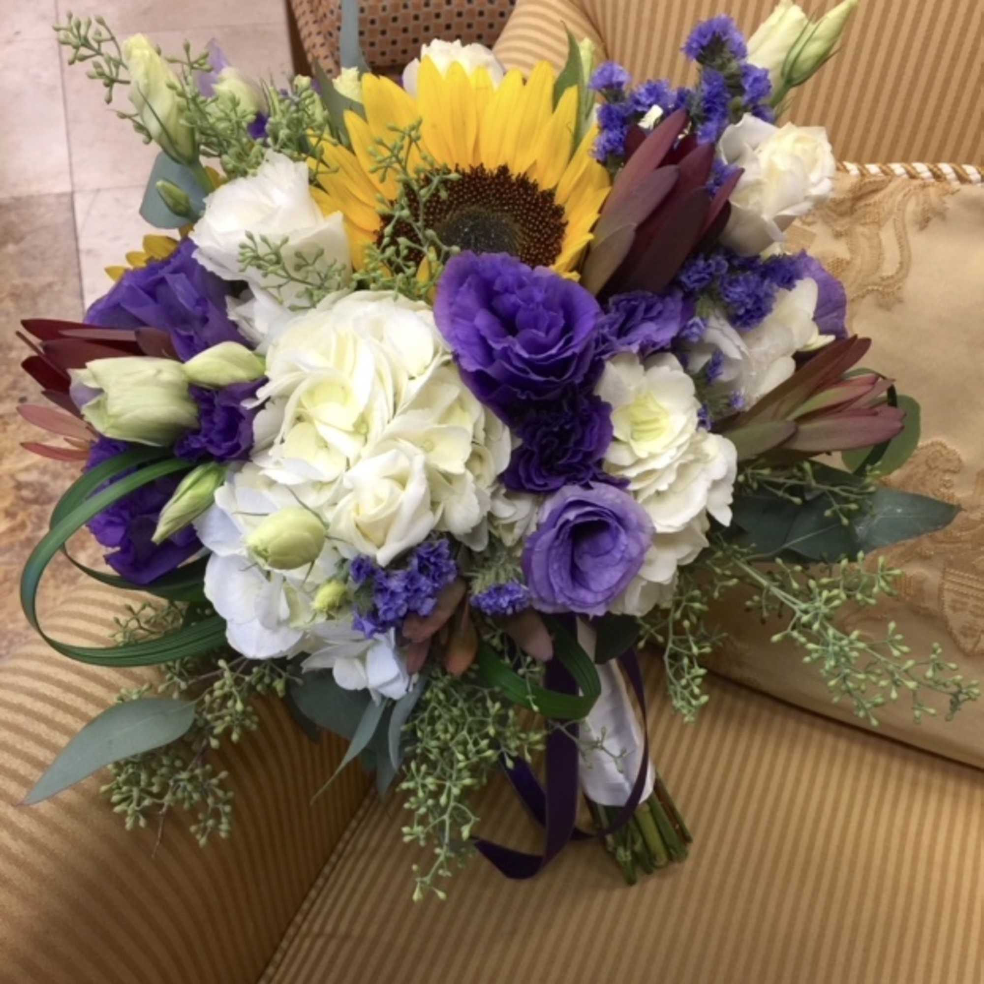 White hydrangeas, sunflowers, purple lisianthus, white lisianthus, purple statice, mini calla lily
