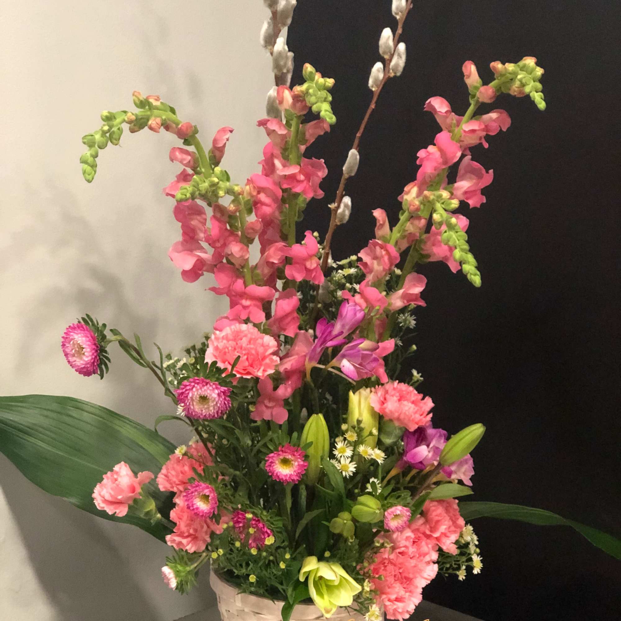 Bright pink and purple blossoms seem to burst exuberantly from a natural