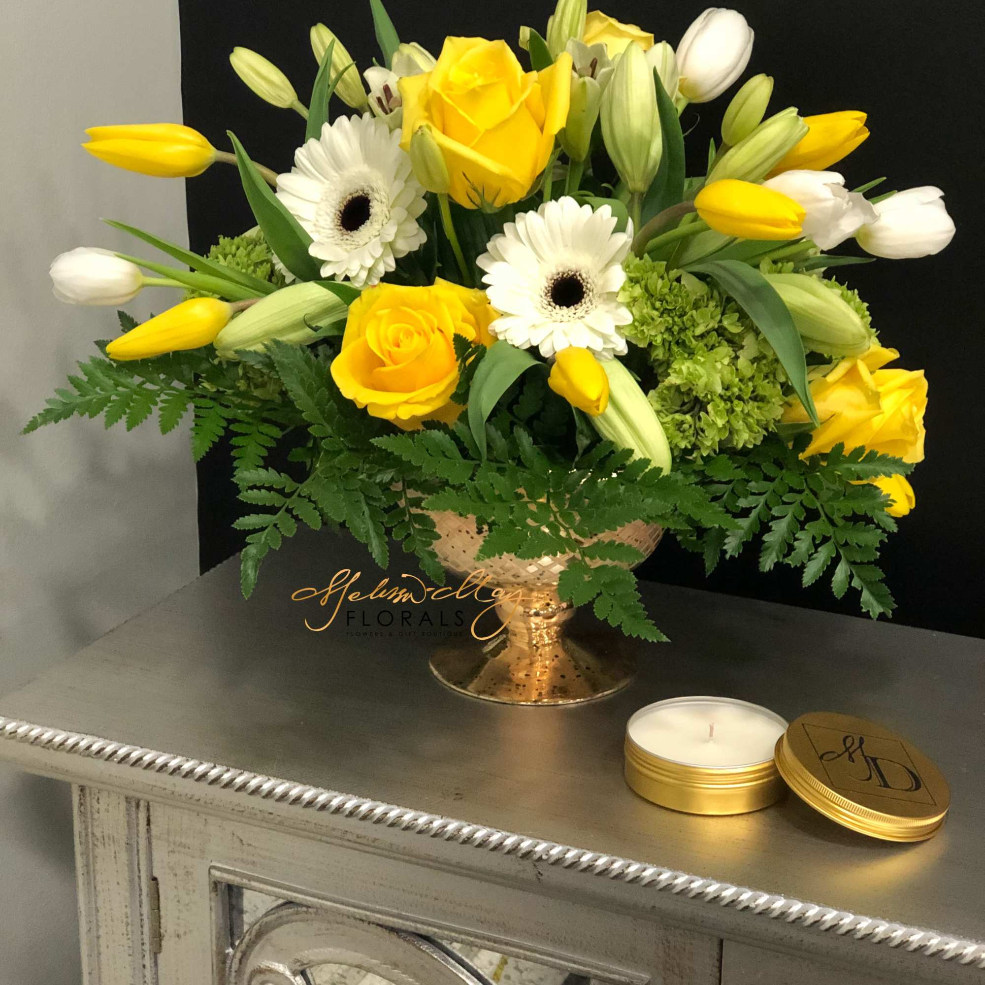 Rich and elegant, this all-yellow and white arrangement is a wonderful remembrance