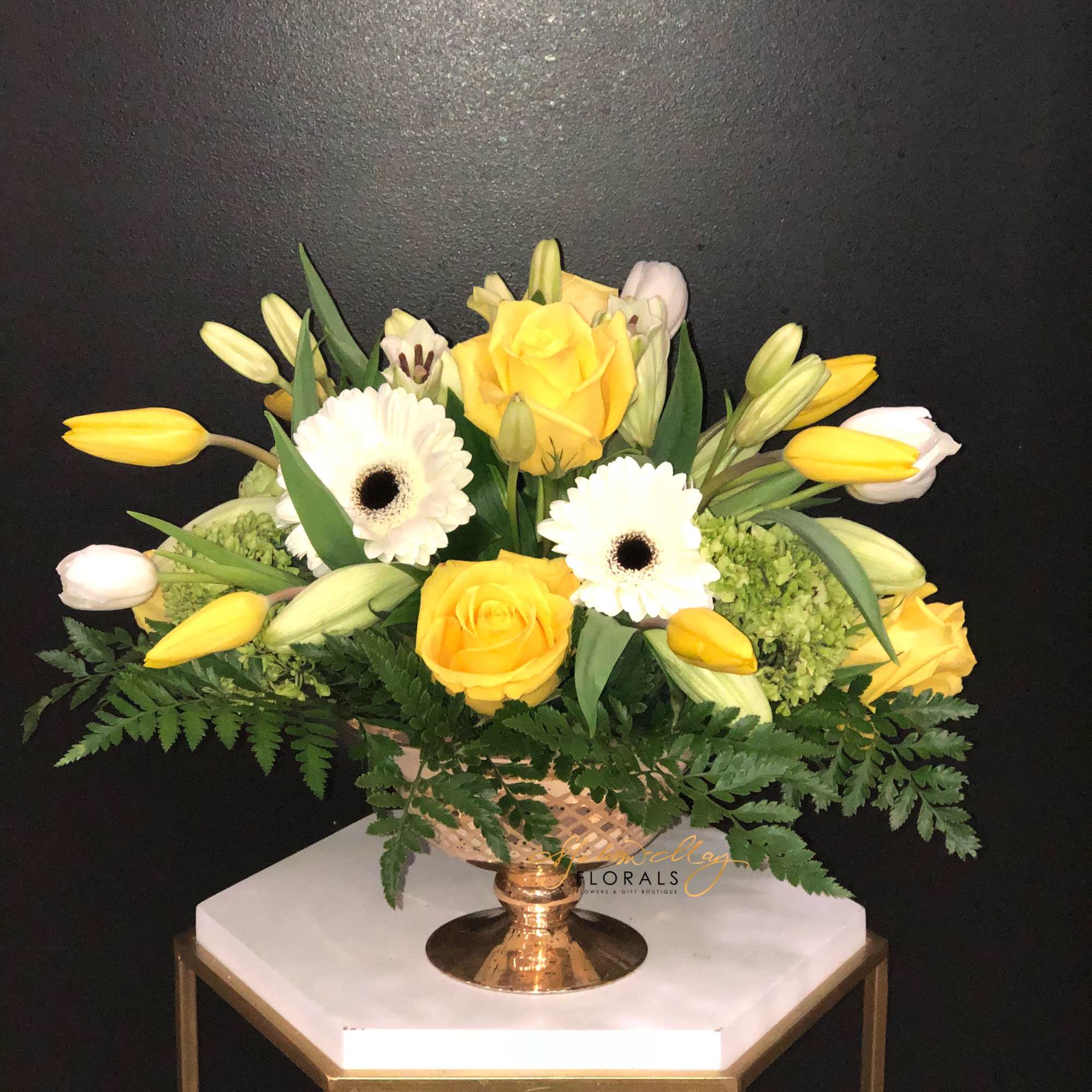 Rich and elegant, this all-yellow and white arrangement is a wonderful remembrance