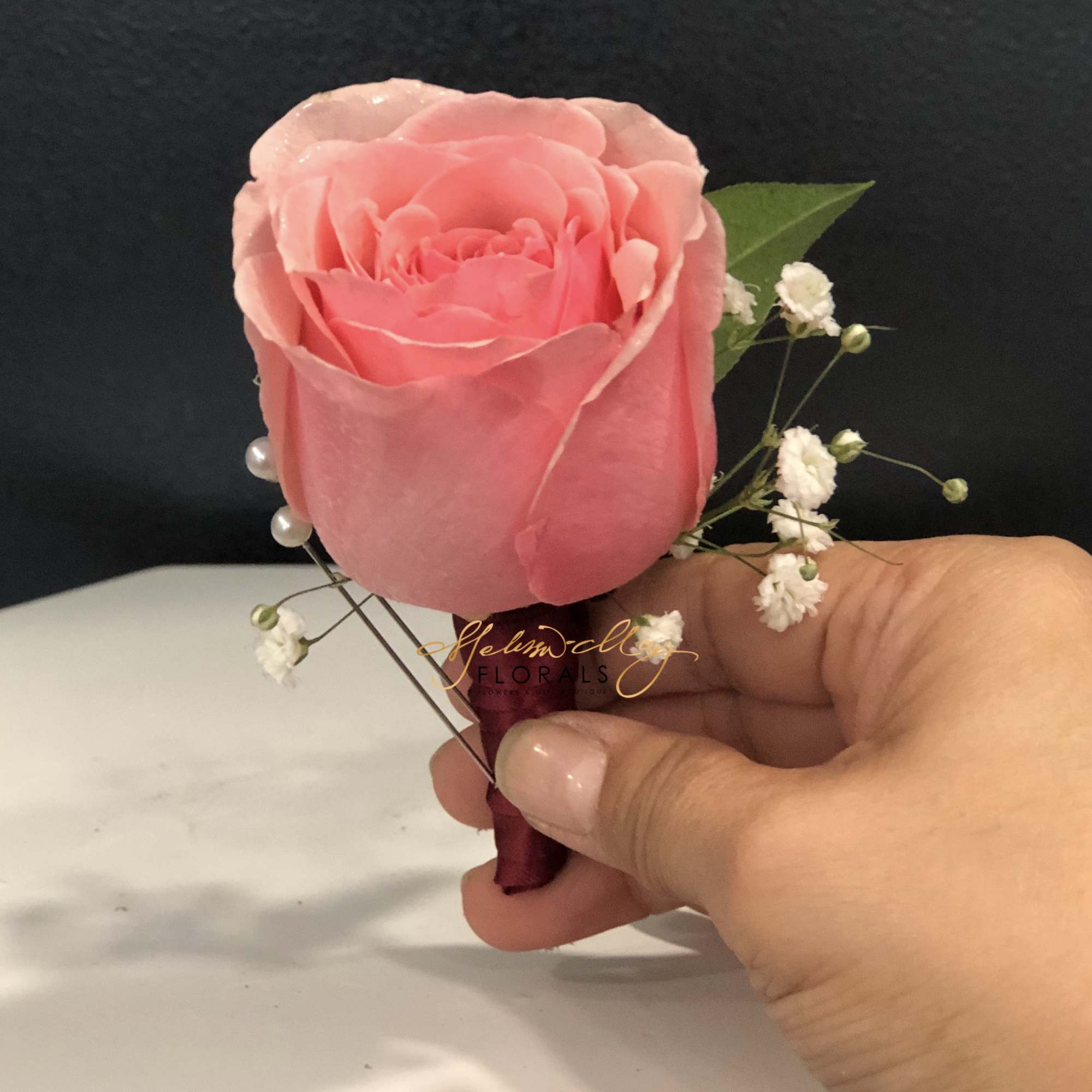 A pink rose with baby breath. The perfect rose to fit on