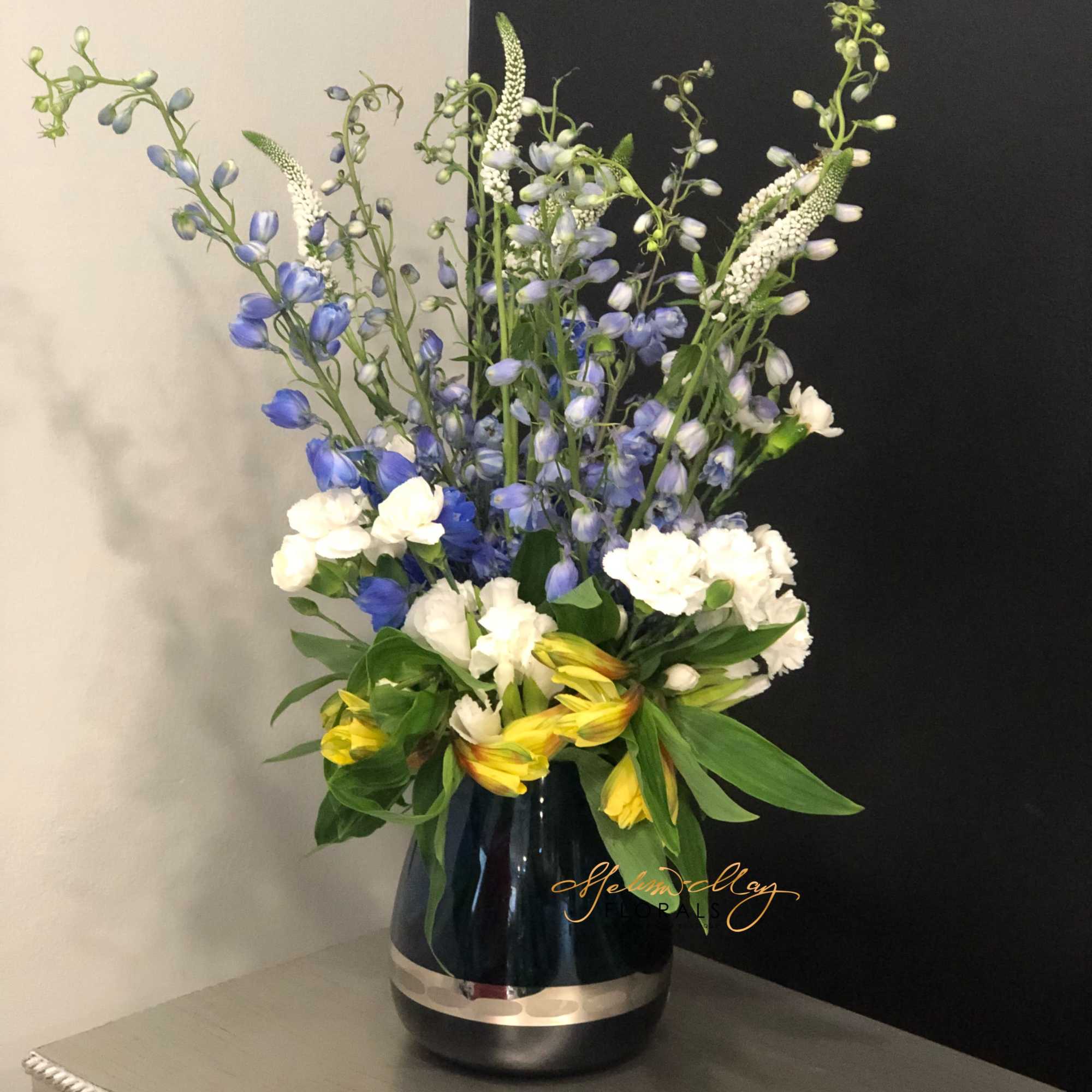 With a touch of the alstroemerias and blue flowers to bring together