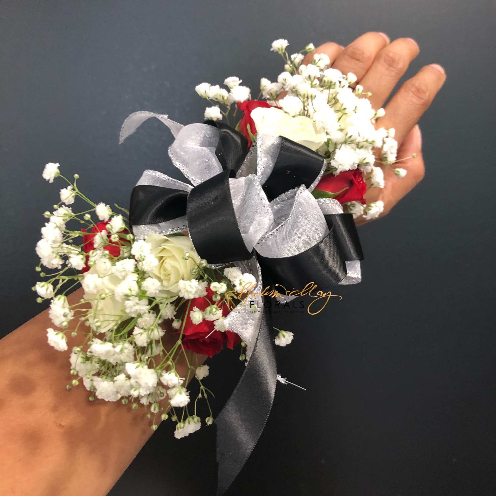 The perfect corsage for a prom date . It has black and