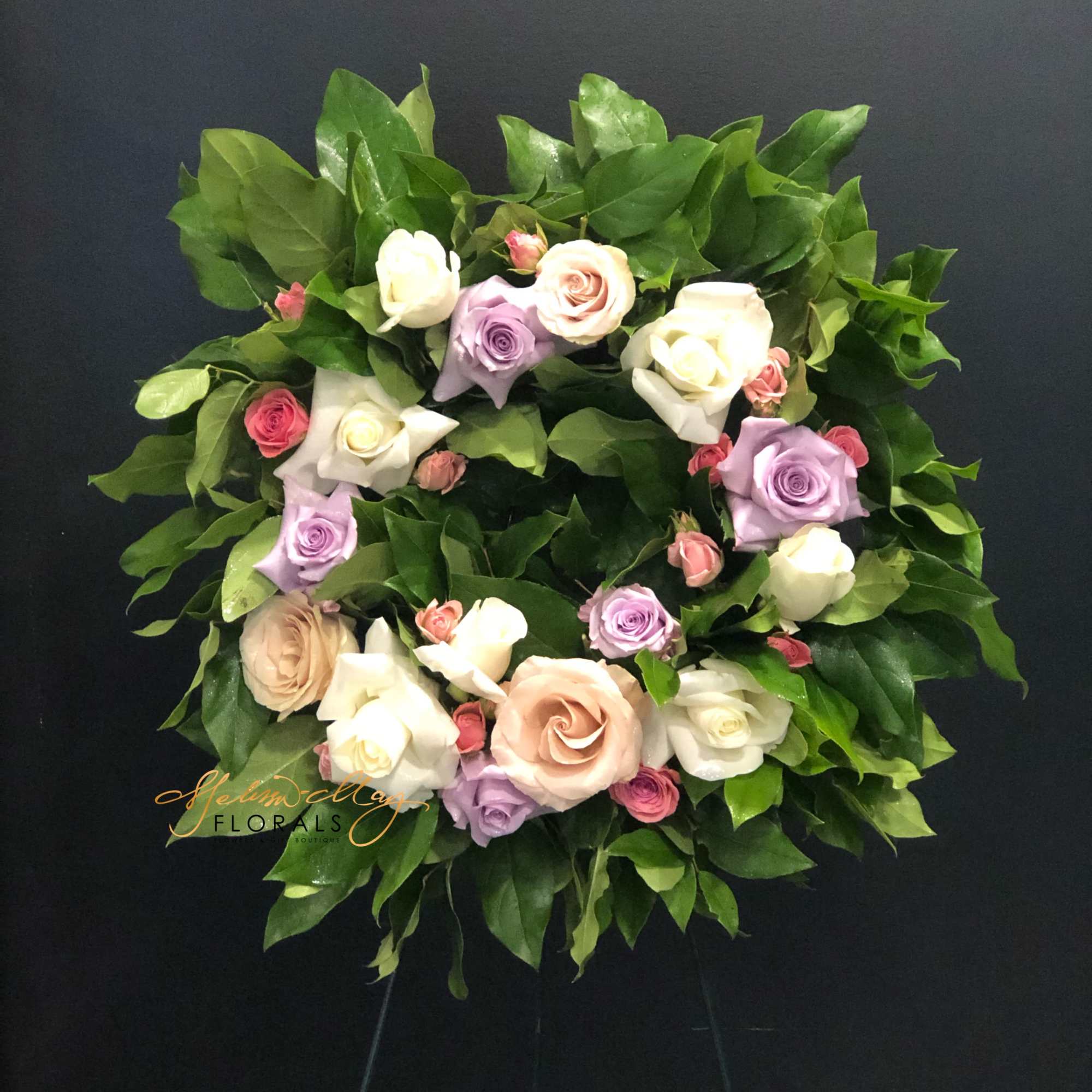 A standing wreath arrangement that can be versatile for various occasions. Beautiful