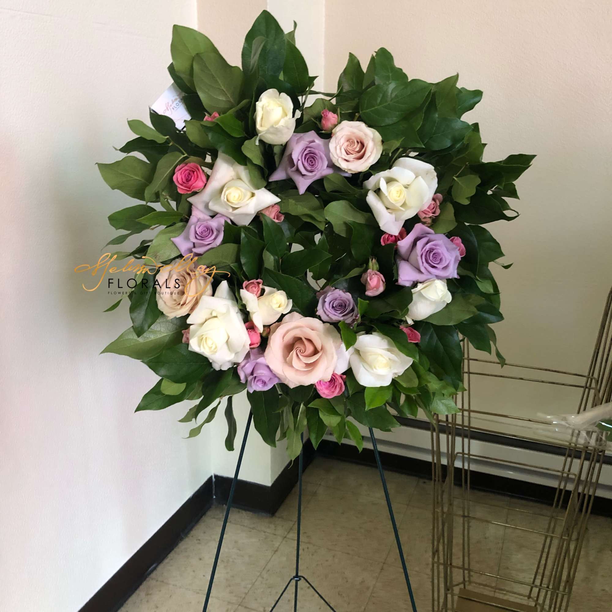 A standing wreath arrangement that can be versatile for various occasions. Beautiful