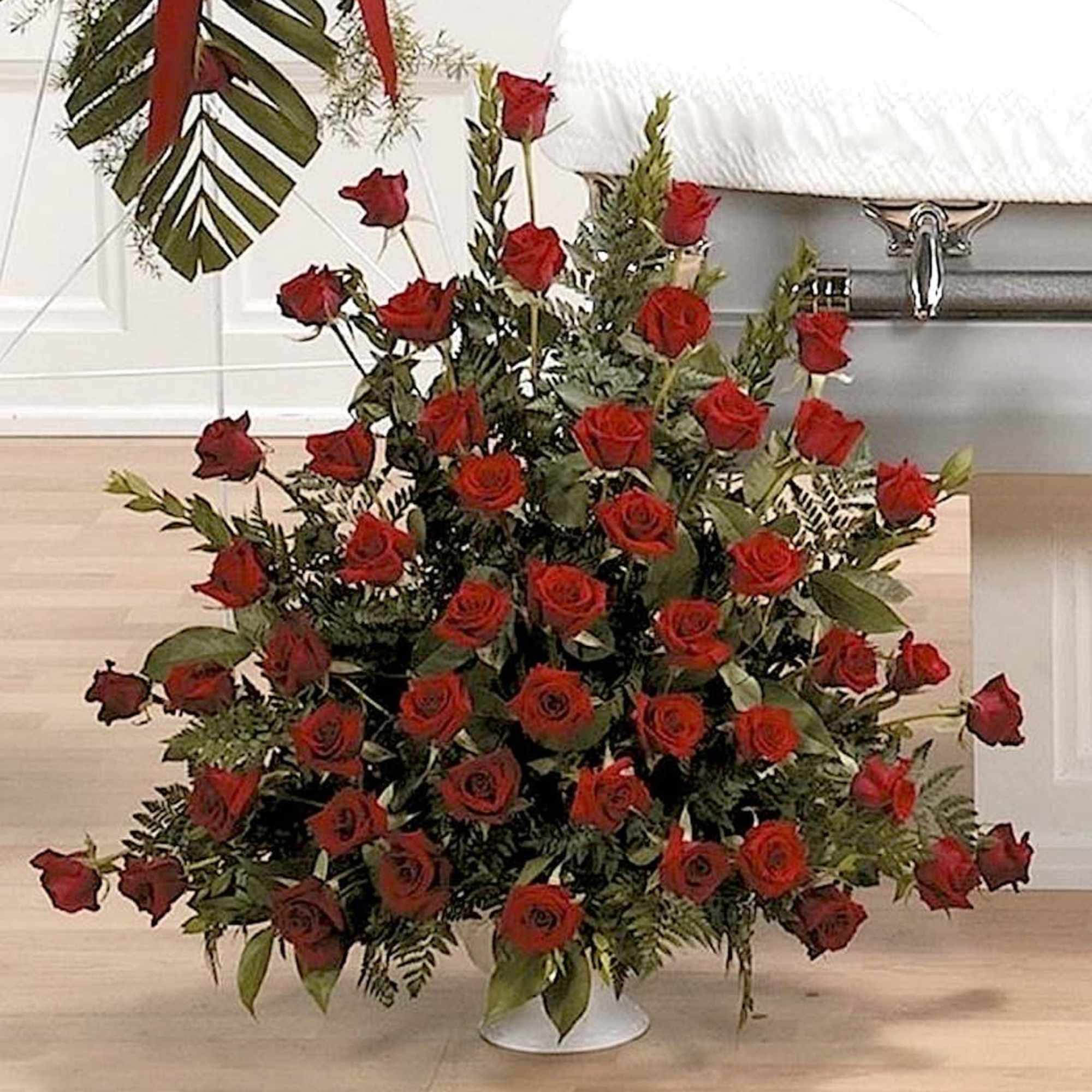 Stunning presentation of red roses filling a large floral urn and representing