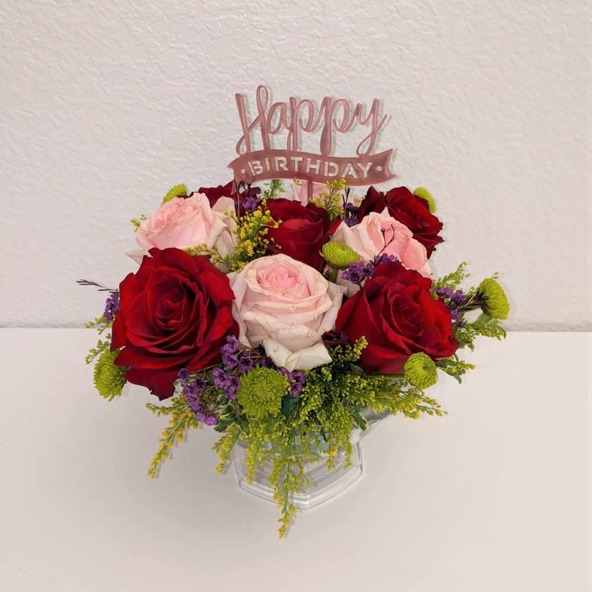 A beautiful mid sized cup filled with various fresh flowers! Great for