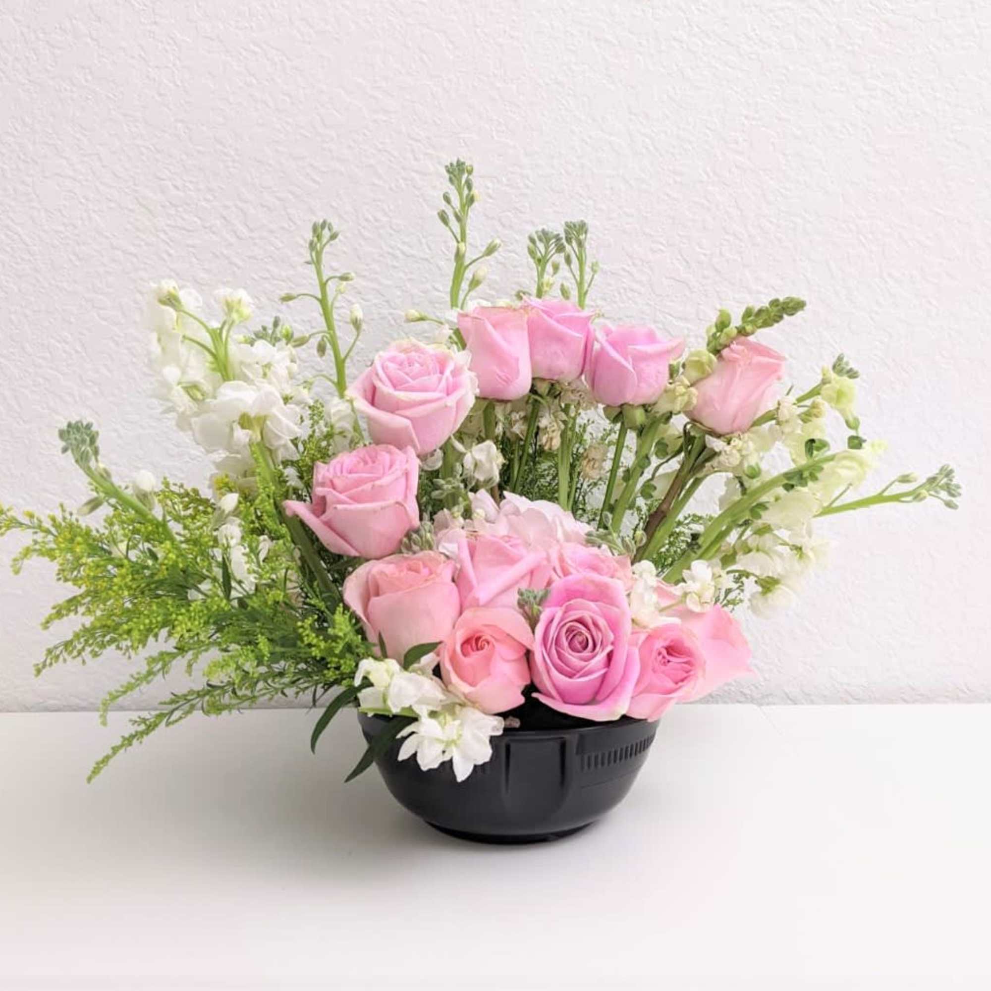 A beautiful bowl of roses curved like a stairway. 