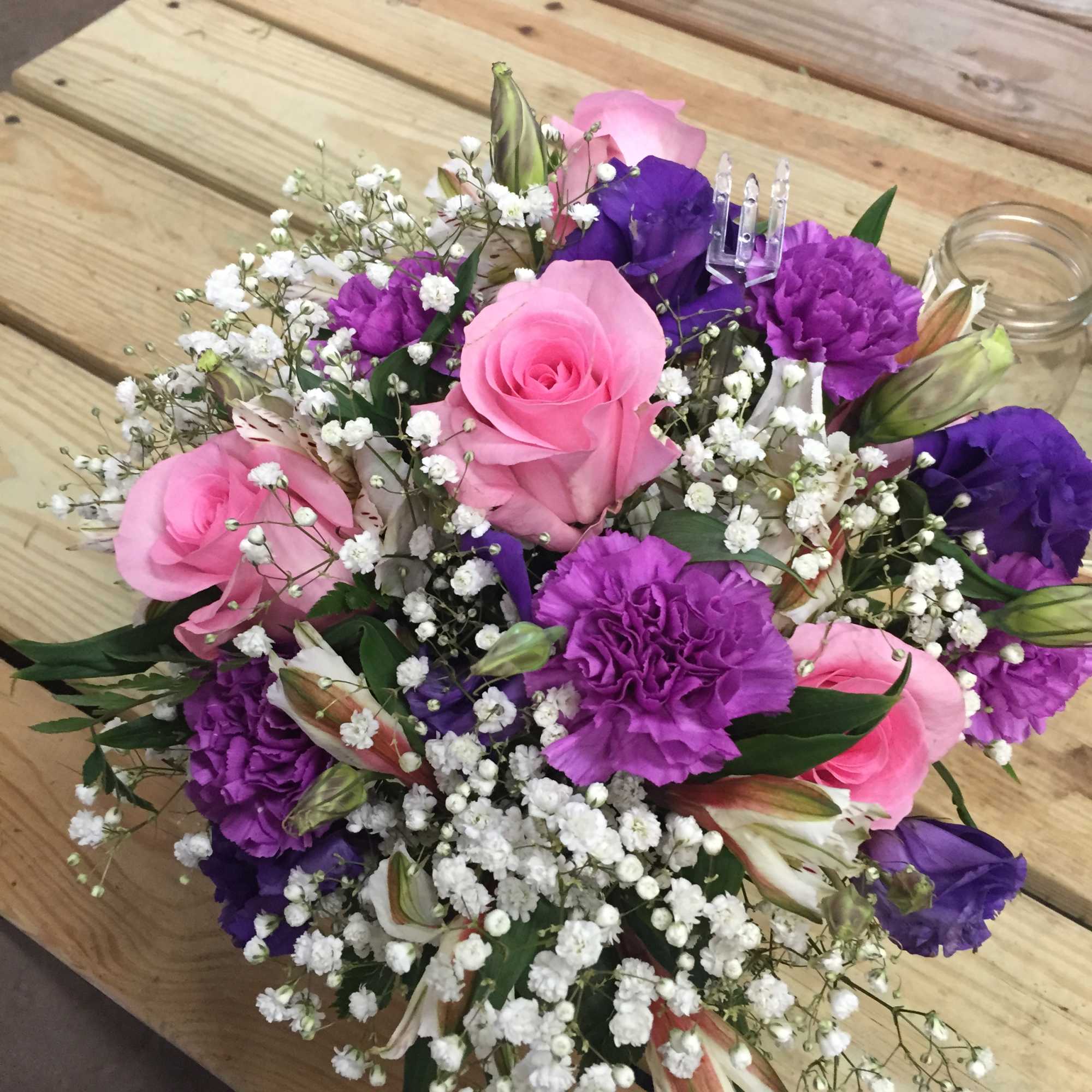 Lavender arrangement has an assortment of lavenders and pinks with roses, carnations Lavender arrangement has an assortment of lavenders and pinks with roses, carnations