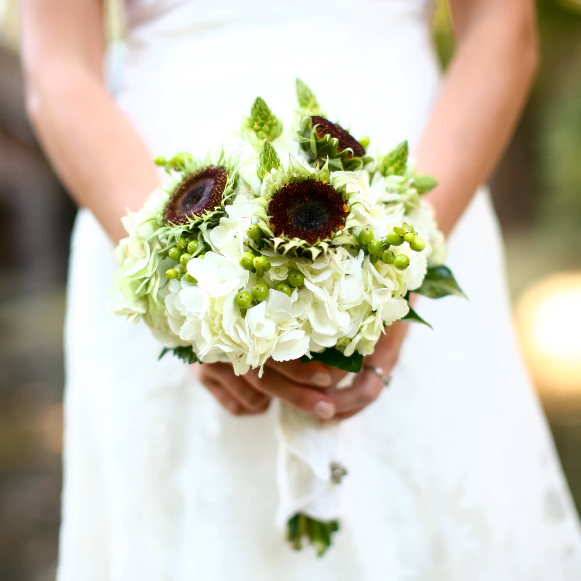 This bouquet has a Antique Hydrangea, White, Ranunculus, Sunflowers that we pulled