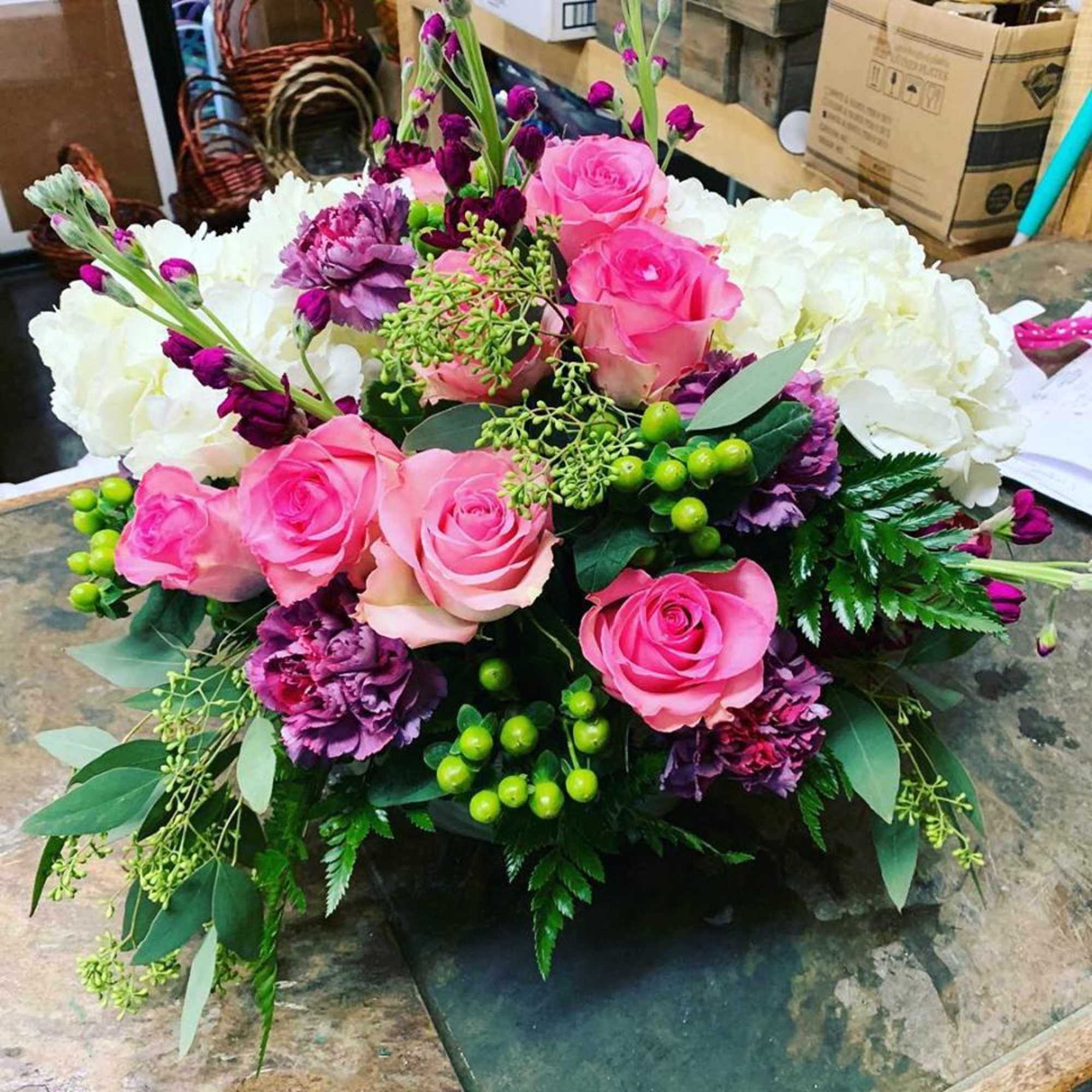 This arrangement is made in a short glazed ceramic container with White This arrangement is made in a short glazed ceramic container with White