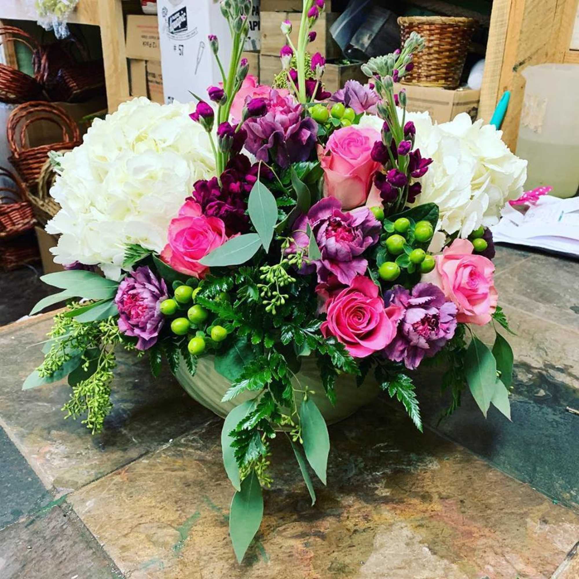 This arrangement is made in a short glazed ceramic container with White This arrangement is made in a short glazed ceramic container with White