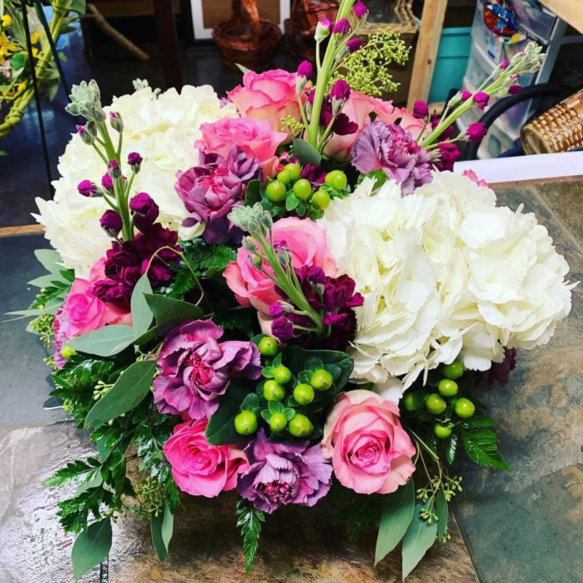 This arrangement is made in a short glazed ceramic container with White This arrangement is made in a short glazed ceramic container with White