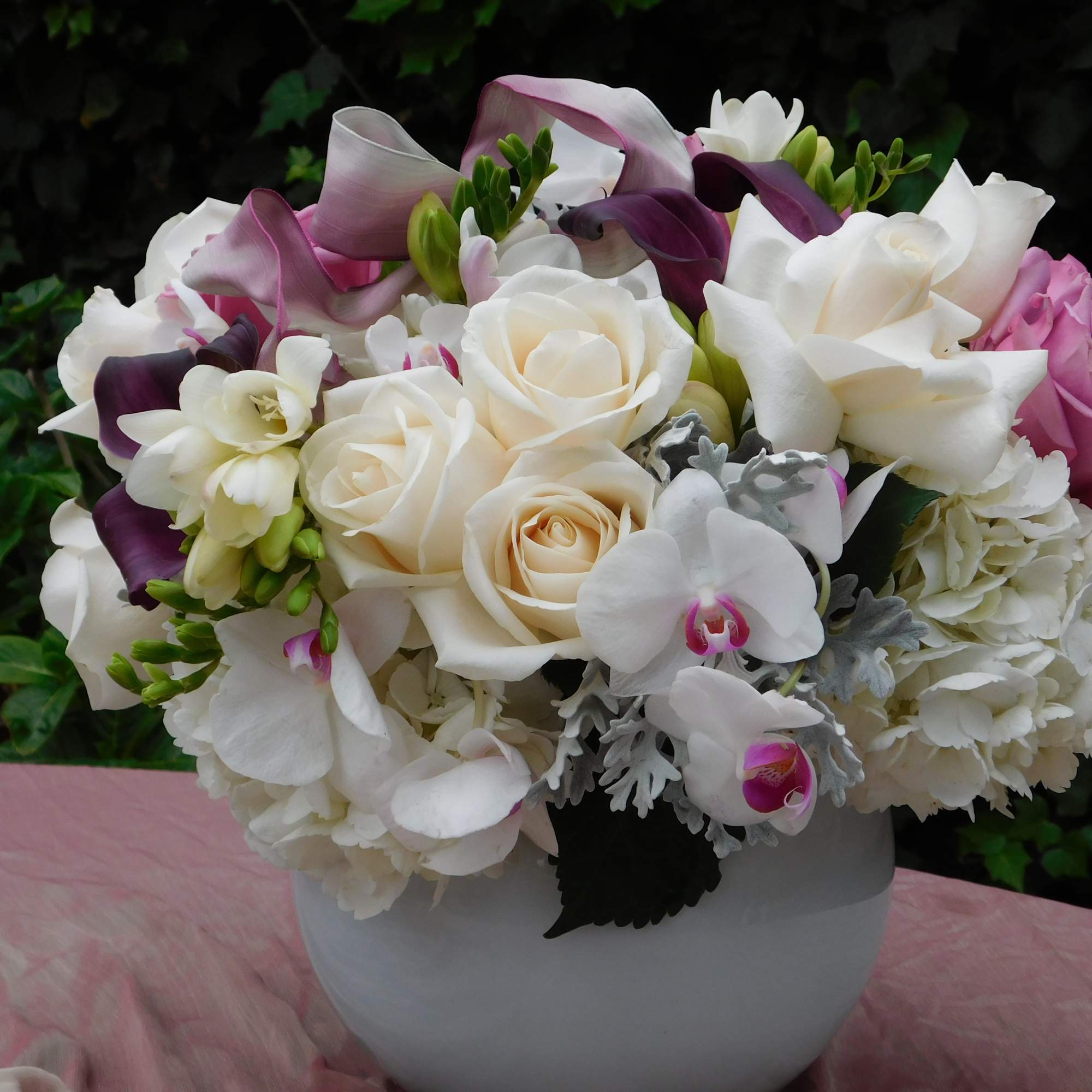 Mixture of white and lavender garden Roses, elegant white Orchids and Freesias Mixture of white and lavender garden Roses, elegant white Orchids and Freesias