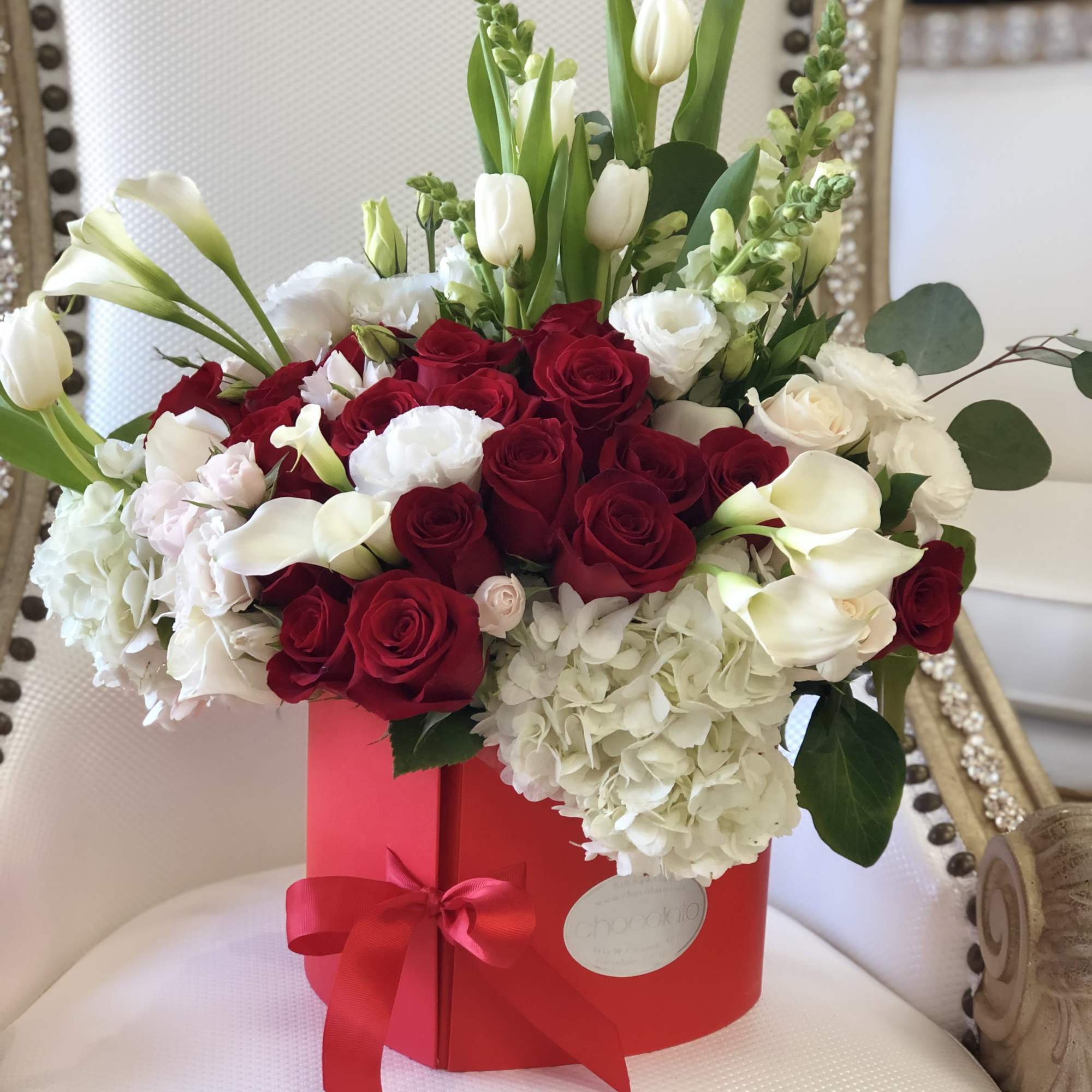 This Chocolato arrangement is made with White Tulips, Red and White Roses
