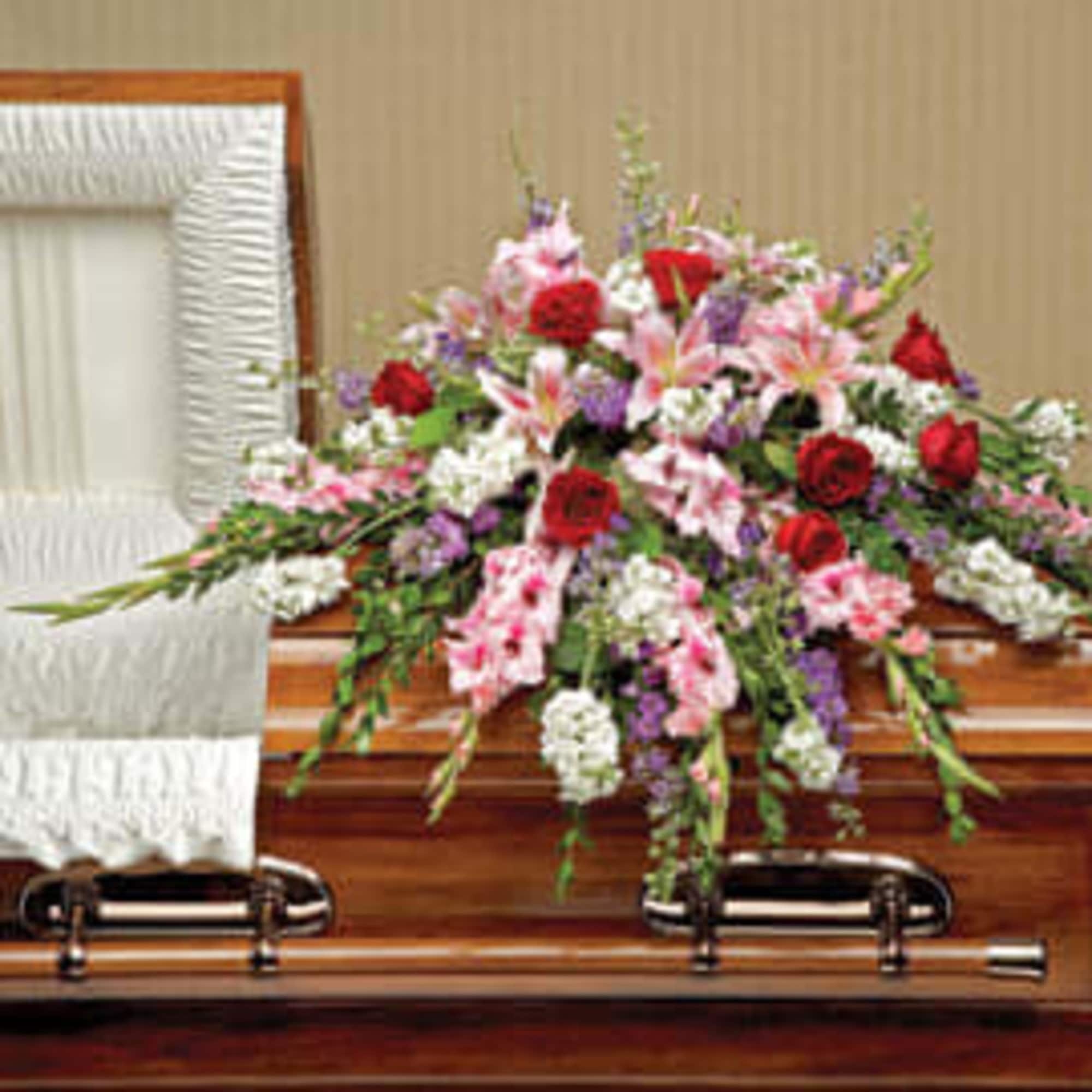 Express your sympathy with a lush and pastoral casket spray of gladioli, photo 2 of 2
