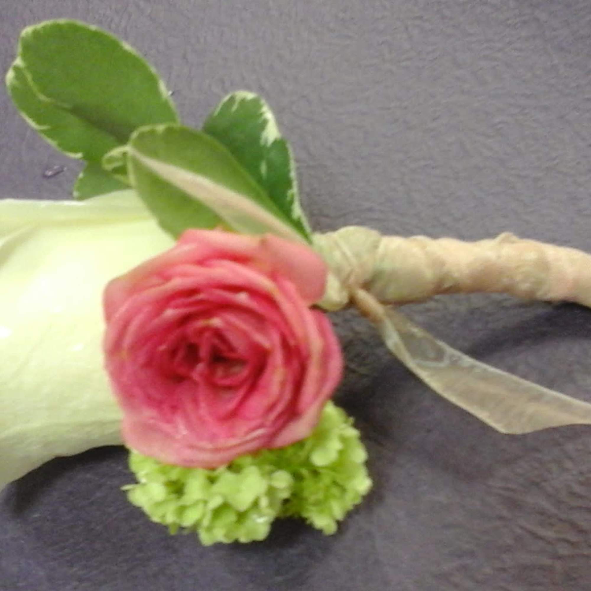 This bountonniere make with white roses,   spray pink roses and
