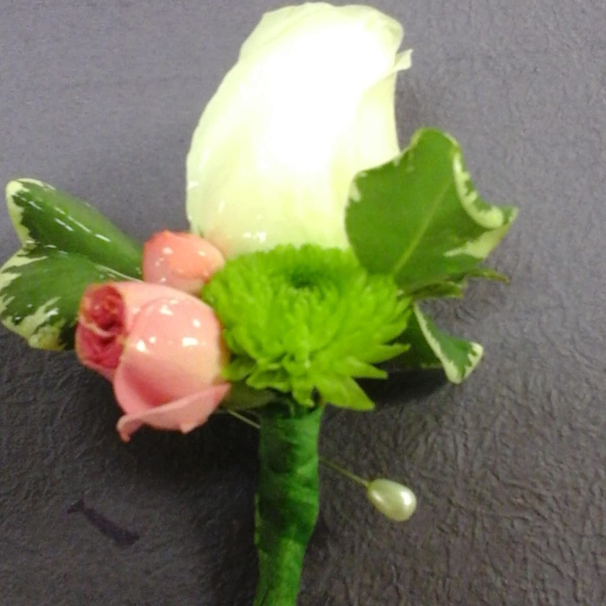 This bountonniere make with white roses,   spray pink roses and