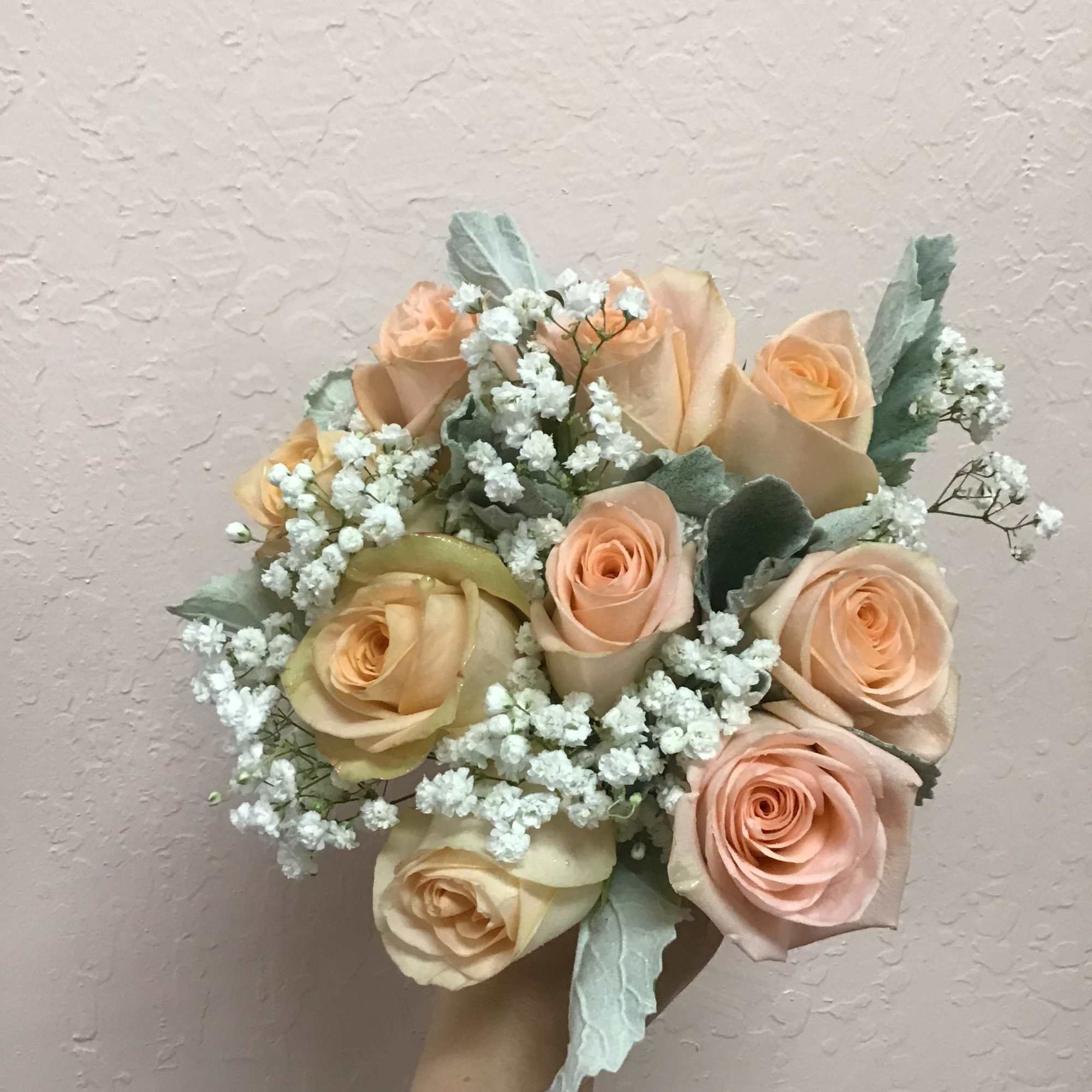 This Hand tie bridal bouquet make with peach roses, baby breath and