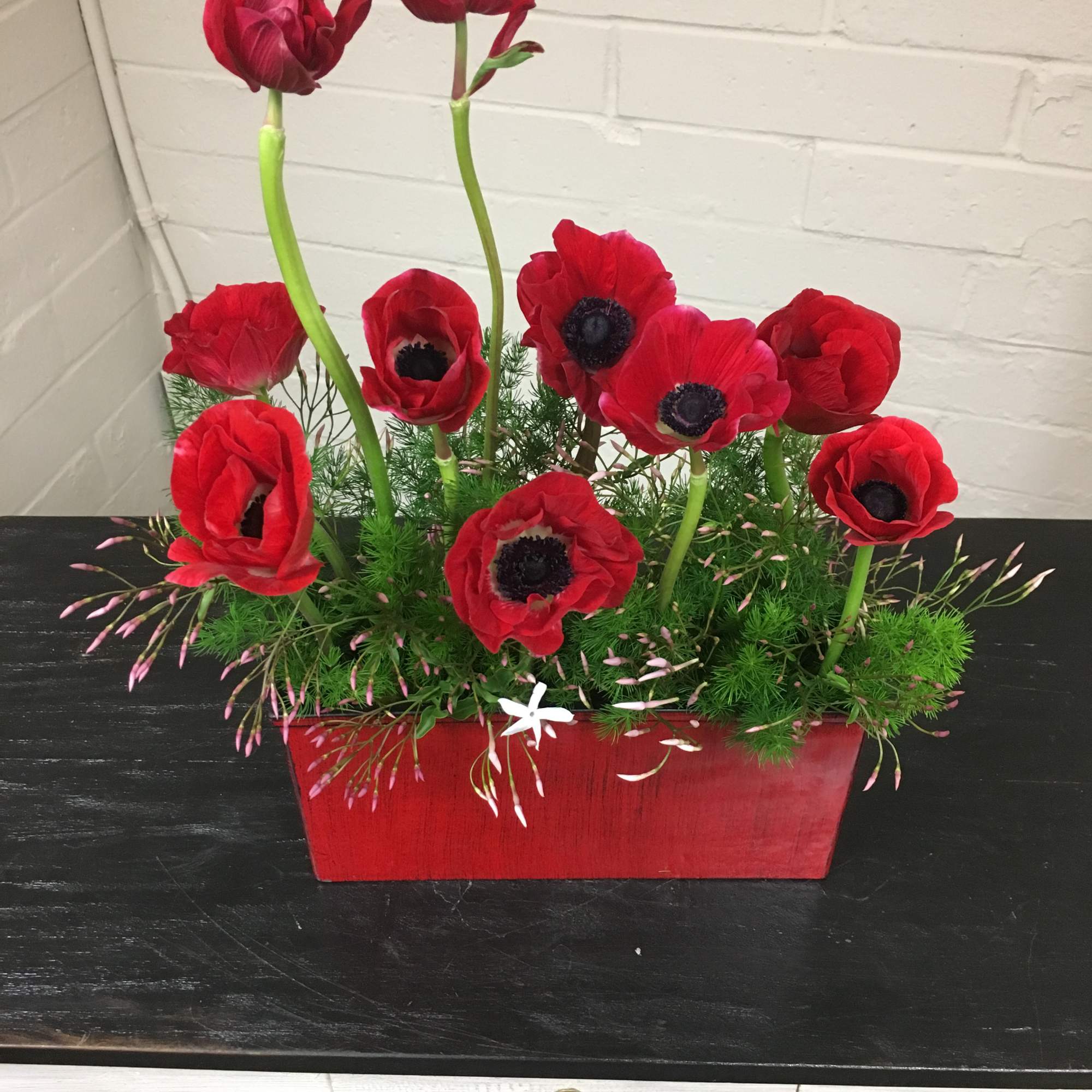 Beautiful arrangement with Anemones, Ming Greens and Jasmine flowers.
Approx Dimensions:  14H