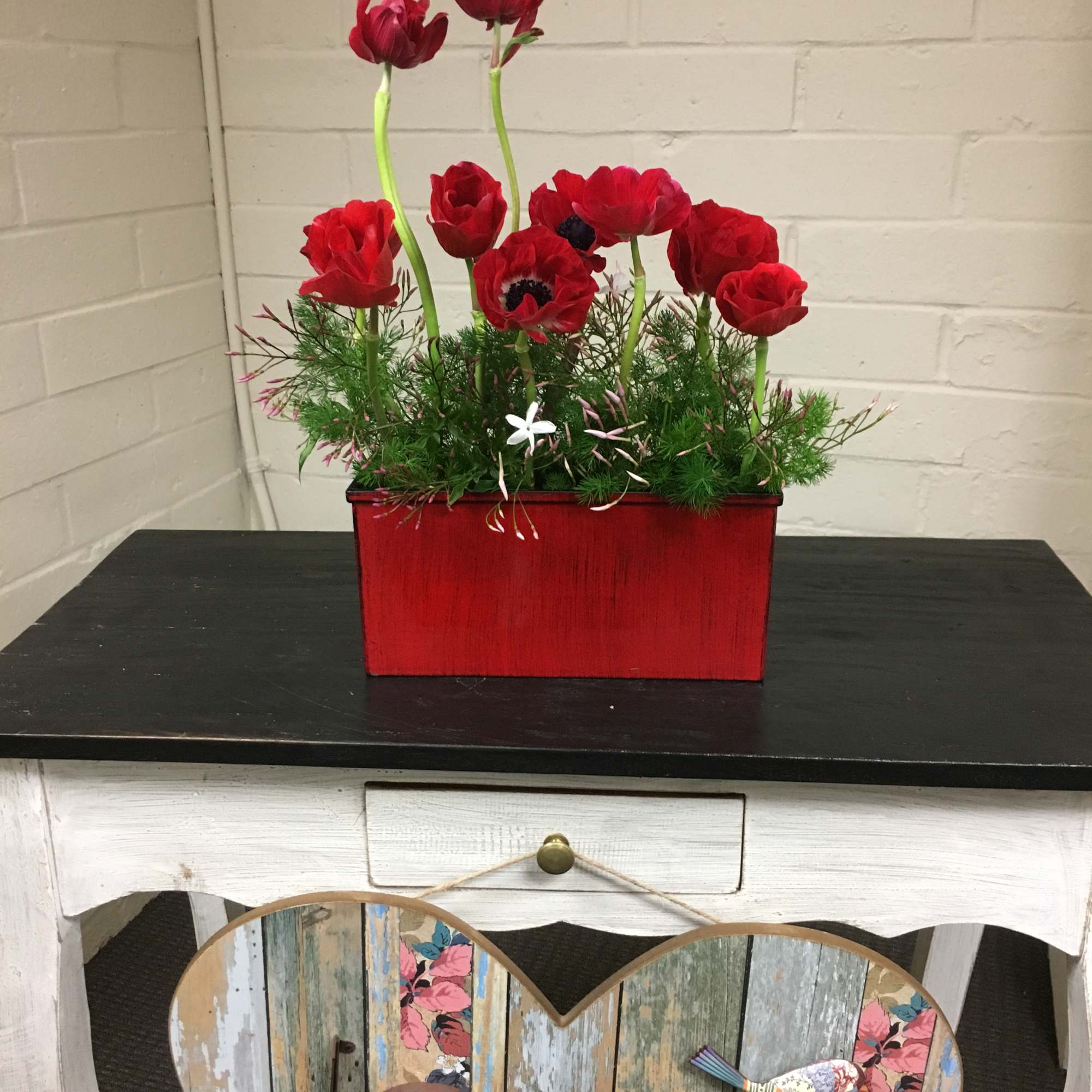 Beautiful arrangement with Anemones, Ming Greens and Jasmine flowers.
Approx Dimensions:  14H