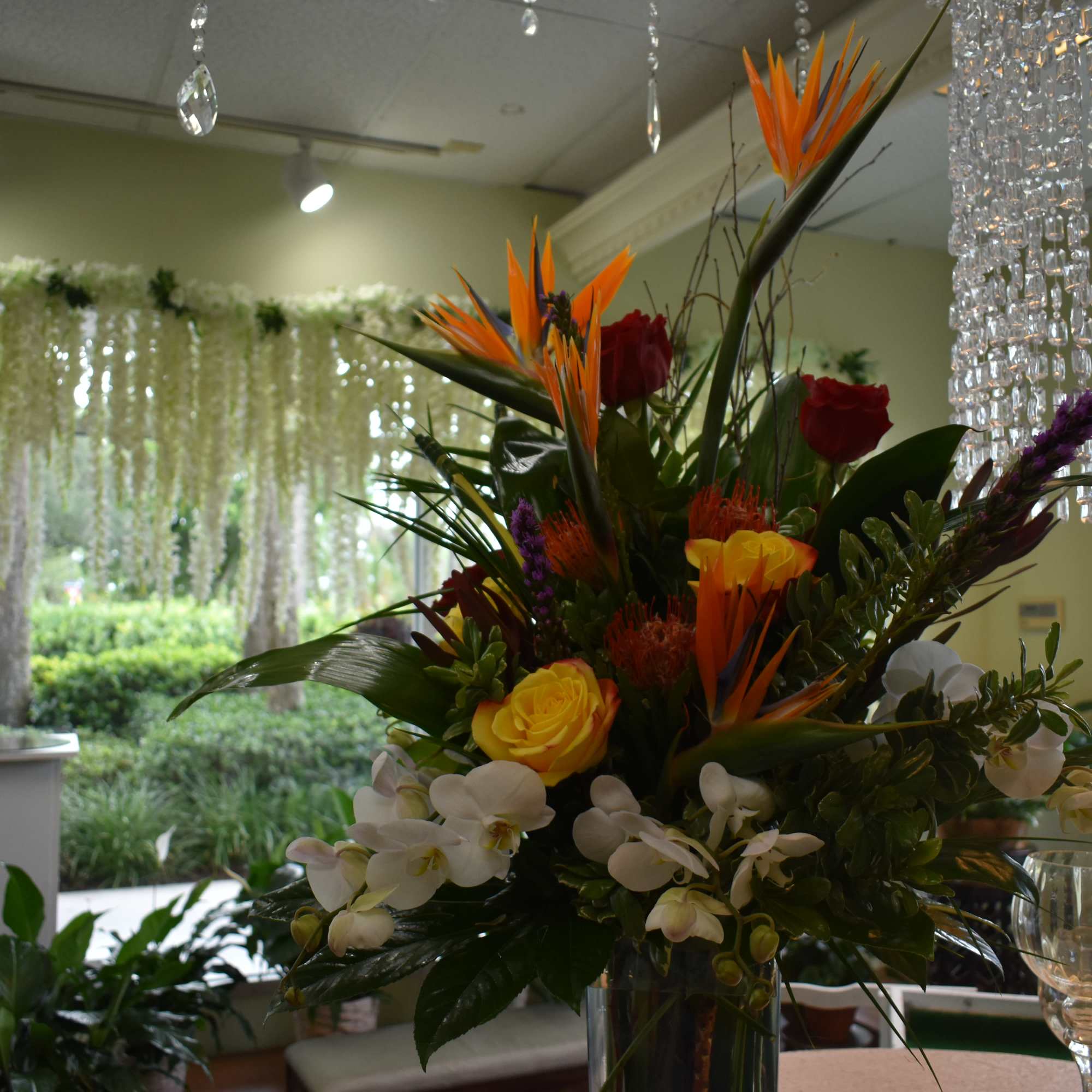 Birds of Paradise, Red Roses, Yellow Roses, White Phalaenopsis, Tropical Greens with