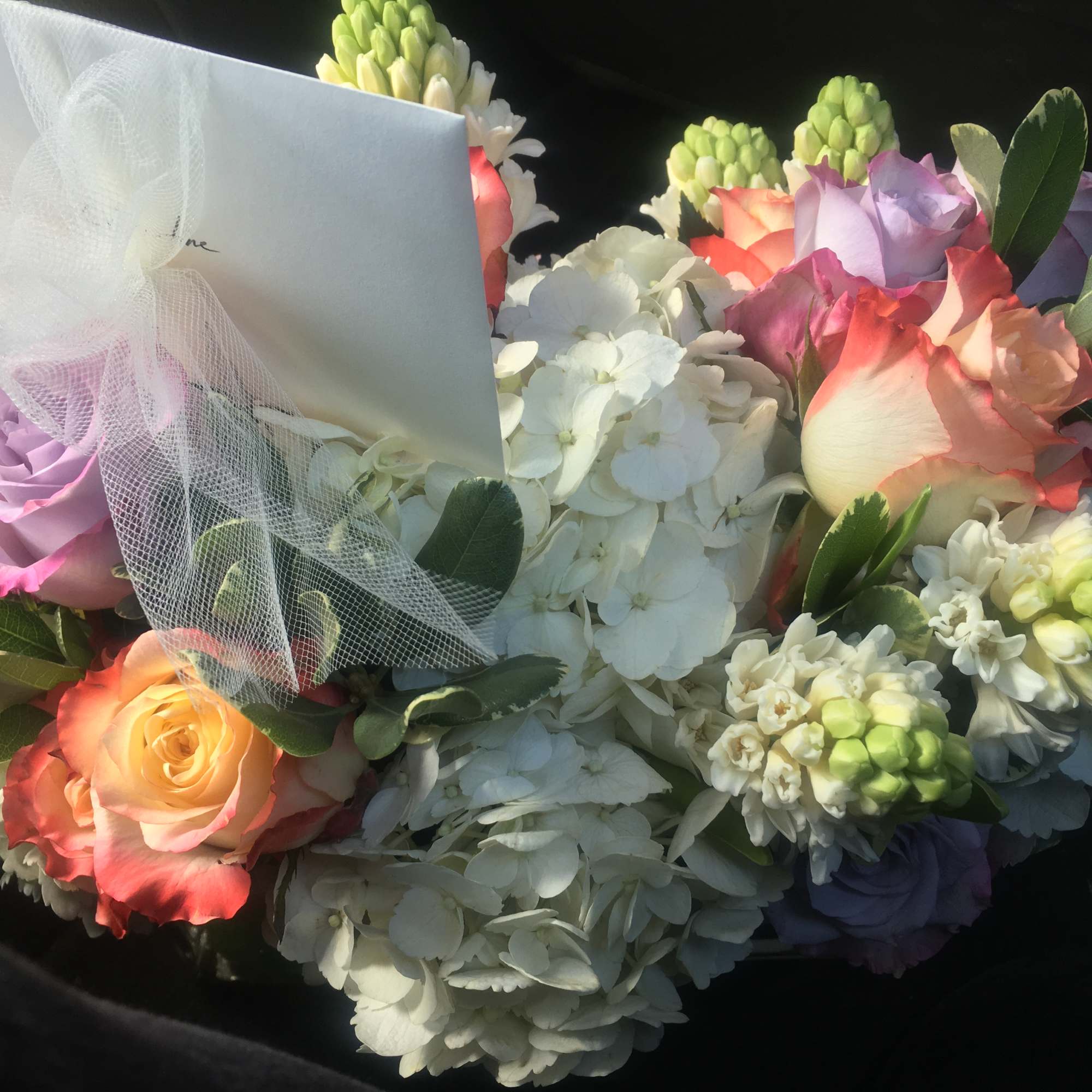 A mixture of beautiful two tone roses, hyacinth, hydrangeas wrapped with tea