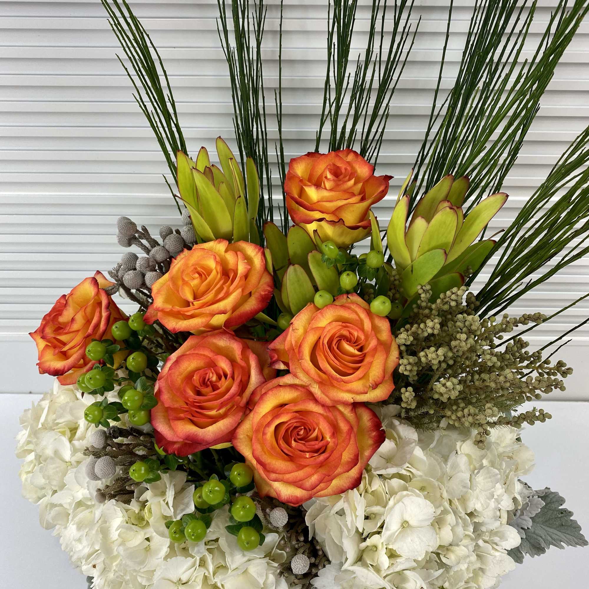 Modern high magic roses, hydrangeas and rich mix of greenery in a