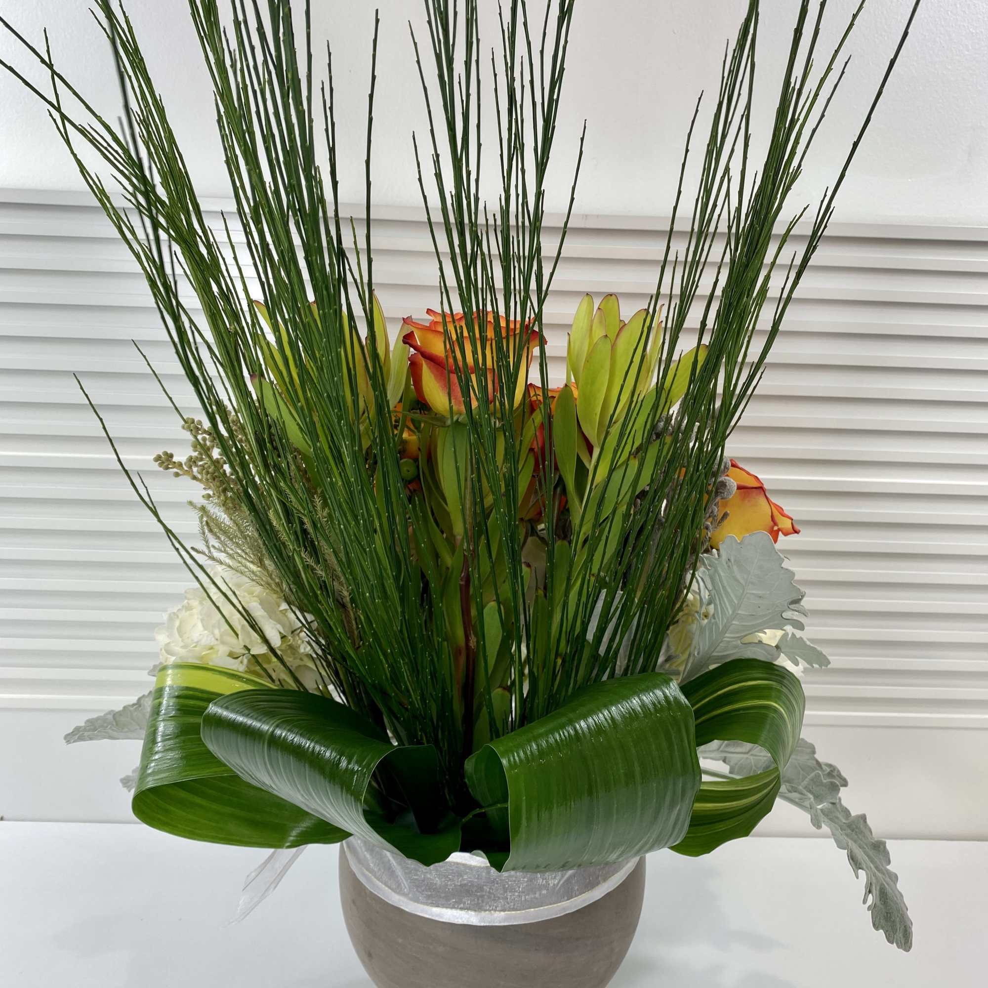 Modern high magic roses, hydrangeas and rich mix of greenery in a