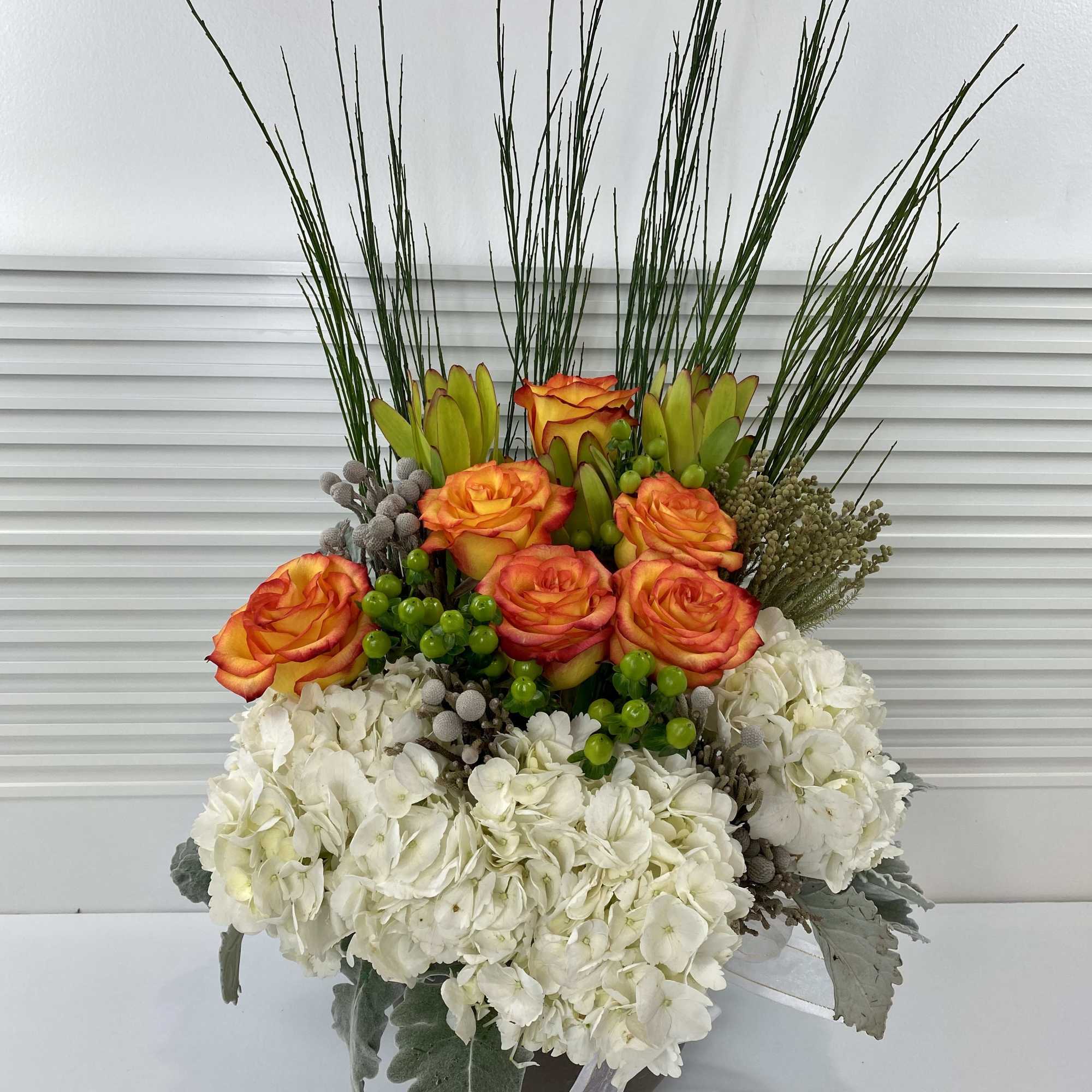 Modern high magic roses, hydrangeas and rich mix of greenery in a