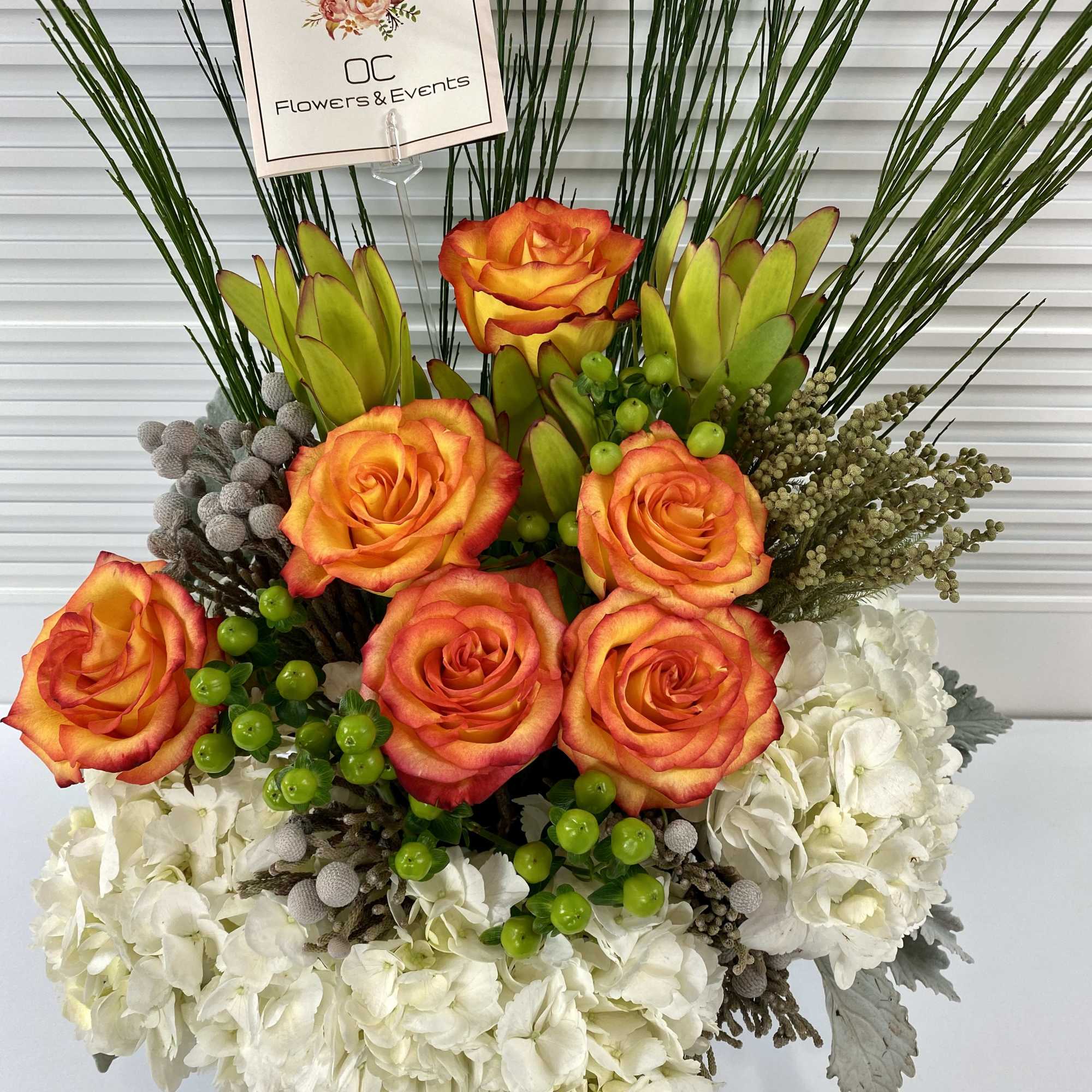 Modern high magic roses, hydrangeas and rich mix of greenery in a