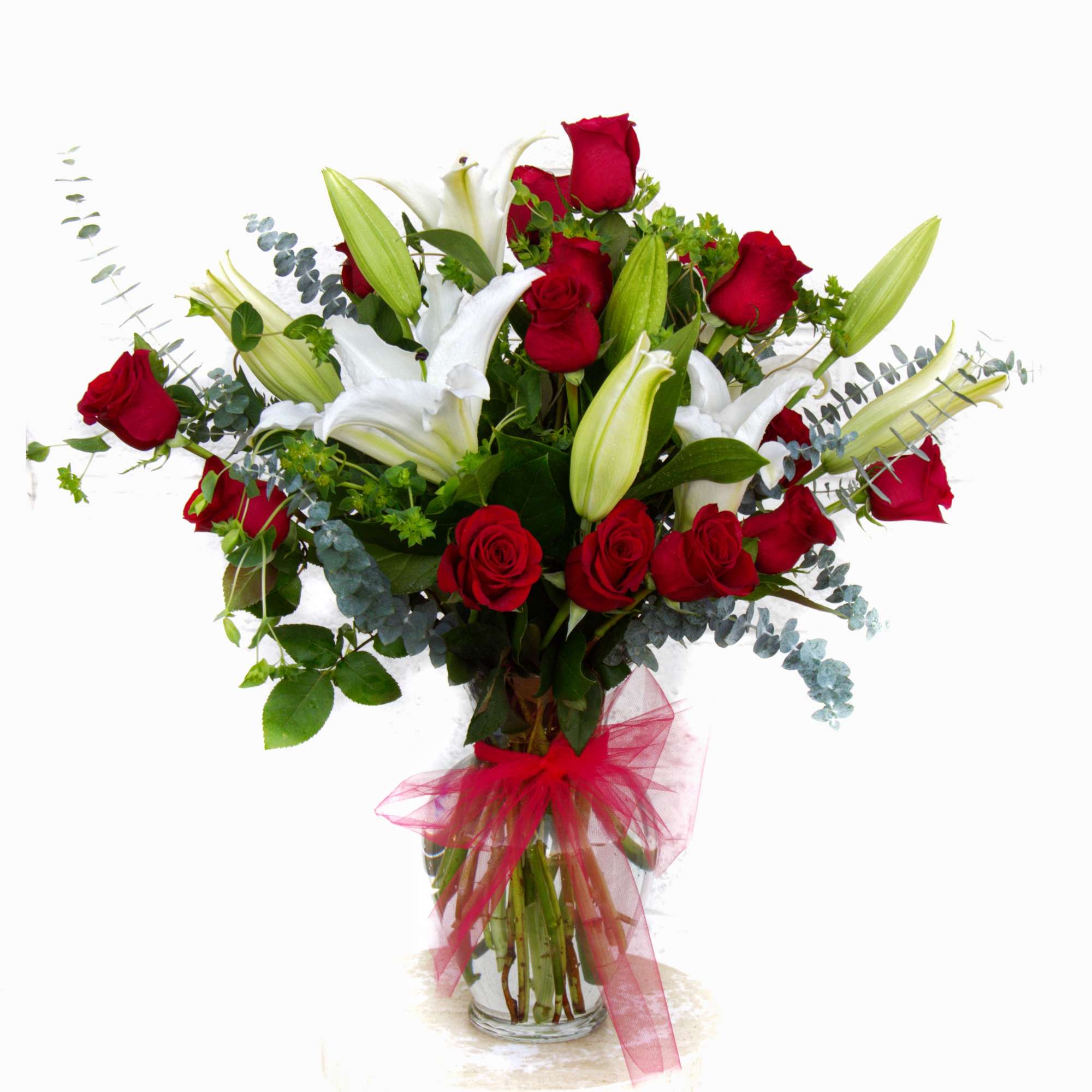 Stargazer lilies, Ecuadorian roses with nice accents in a tall glass vase. Stargazer lilies, Ecuadorian roses with nice accents in a tall glass vase.