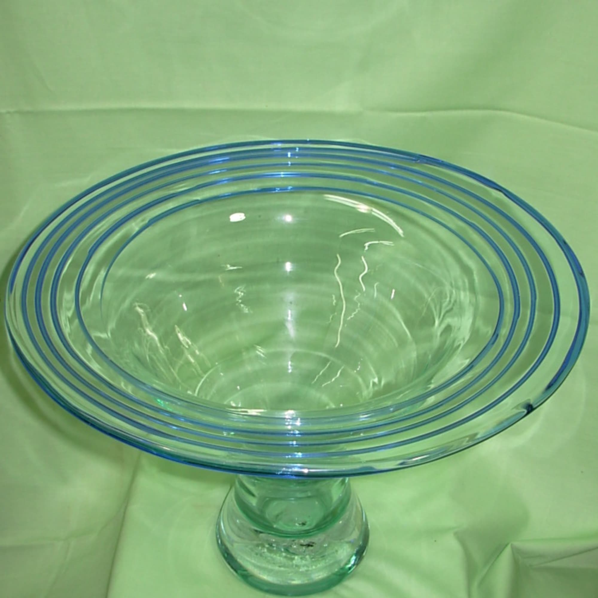 This vintage, mid century modern, hand blown, flared rim, clear and blue