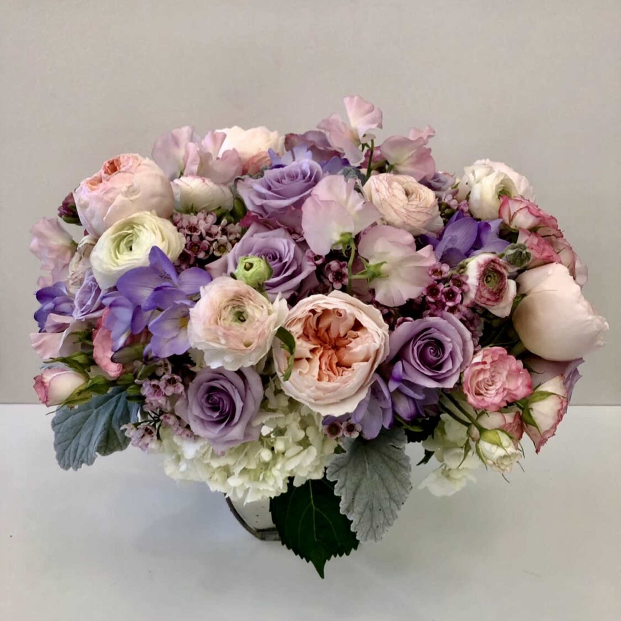 assorted beautiful garden blooms in mercury glass vase