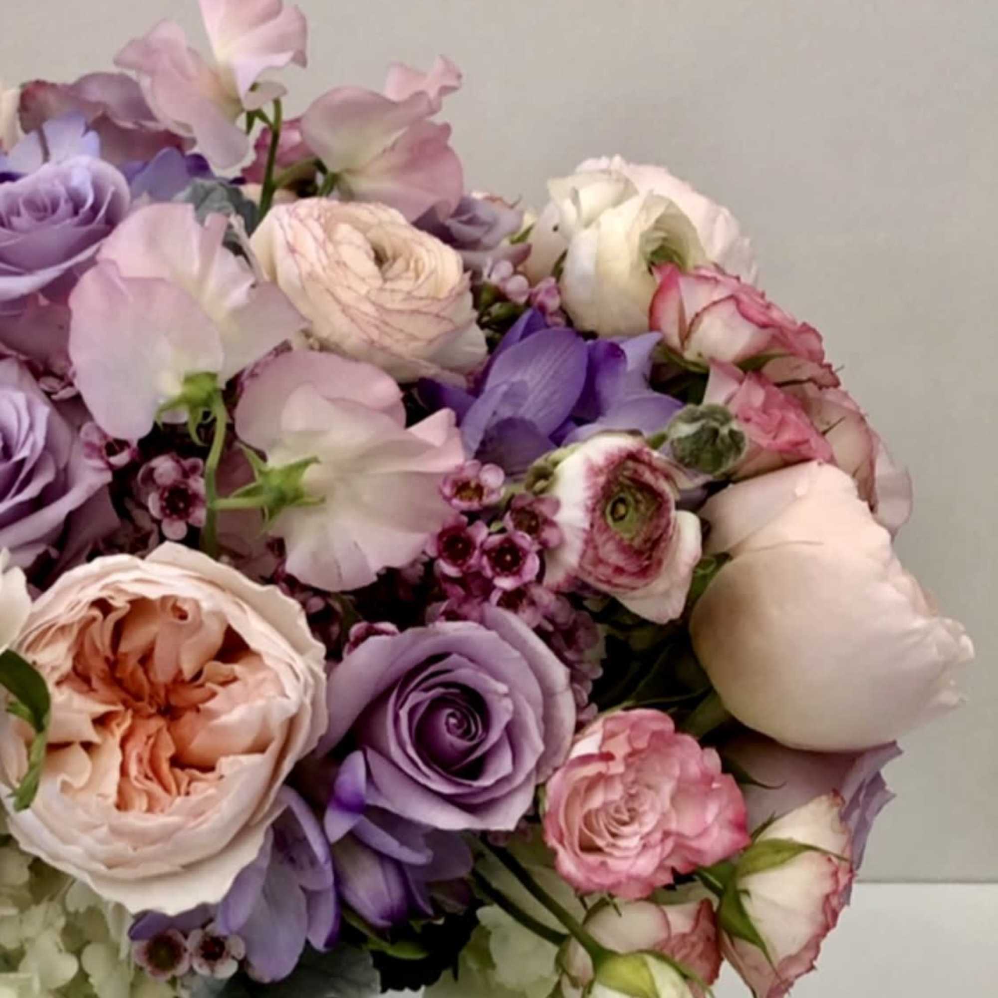 assorted beautiful garden blooms in mercury glass vase