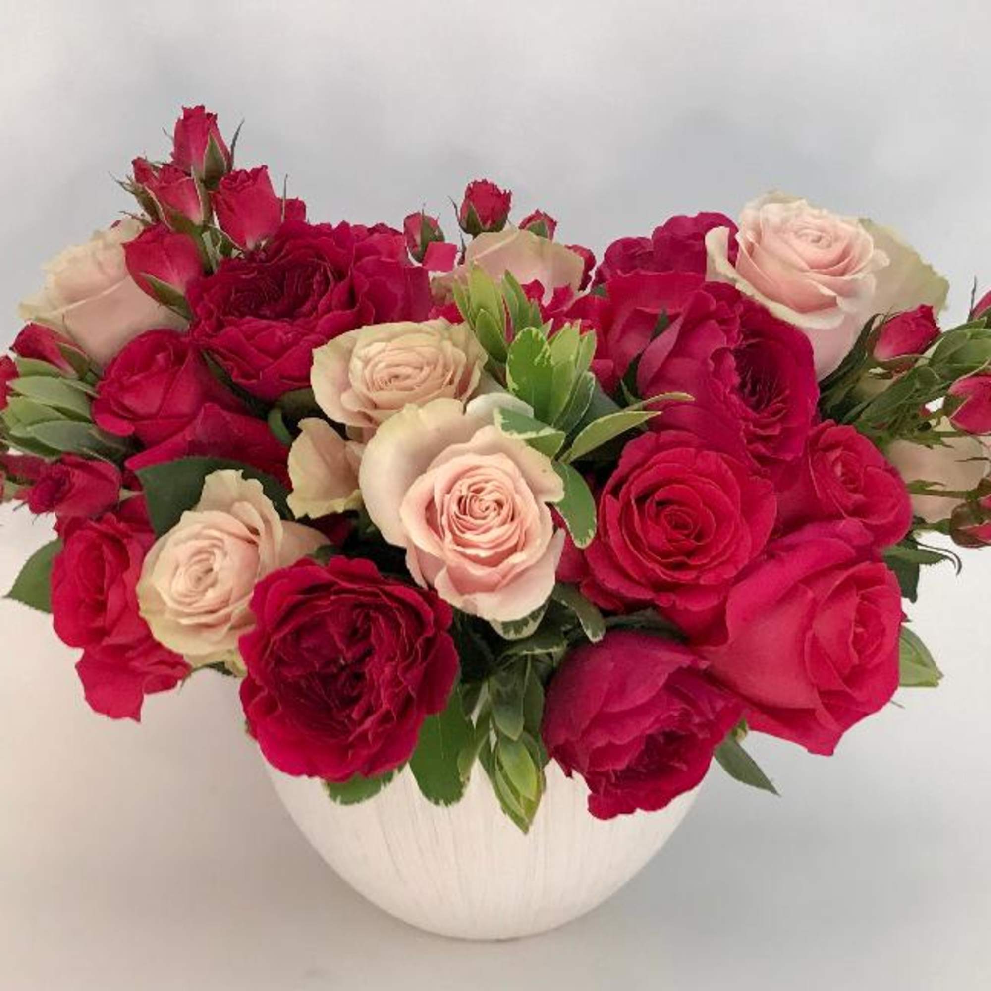 Bountiful arrangement in shades of pink florals garden roses and roses from
