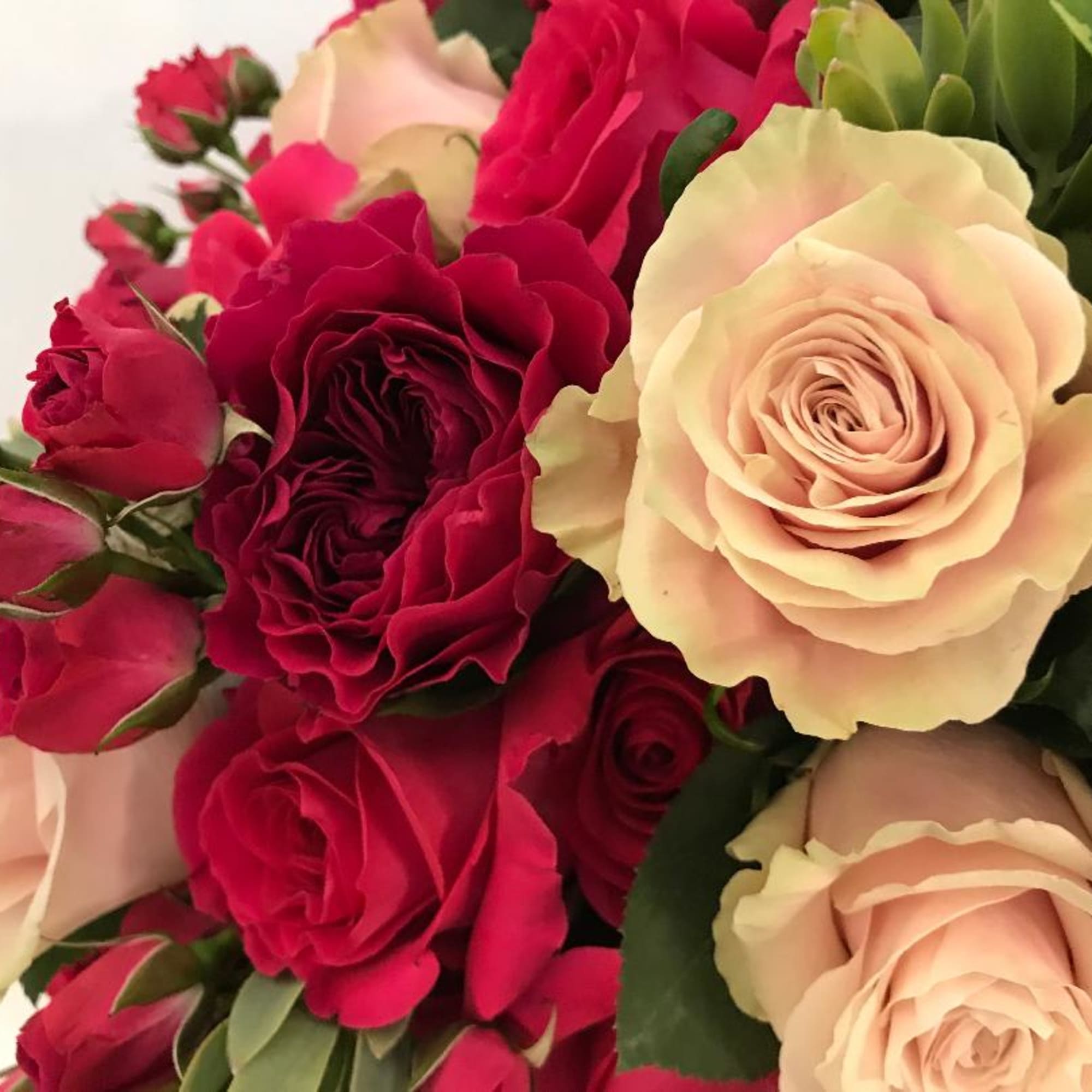 Bountiful arrangement in shades of pink florals garden roses and roses from