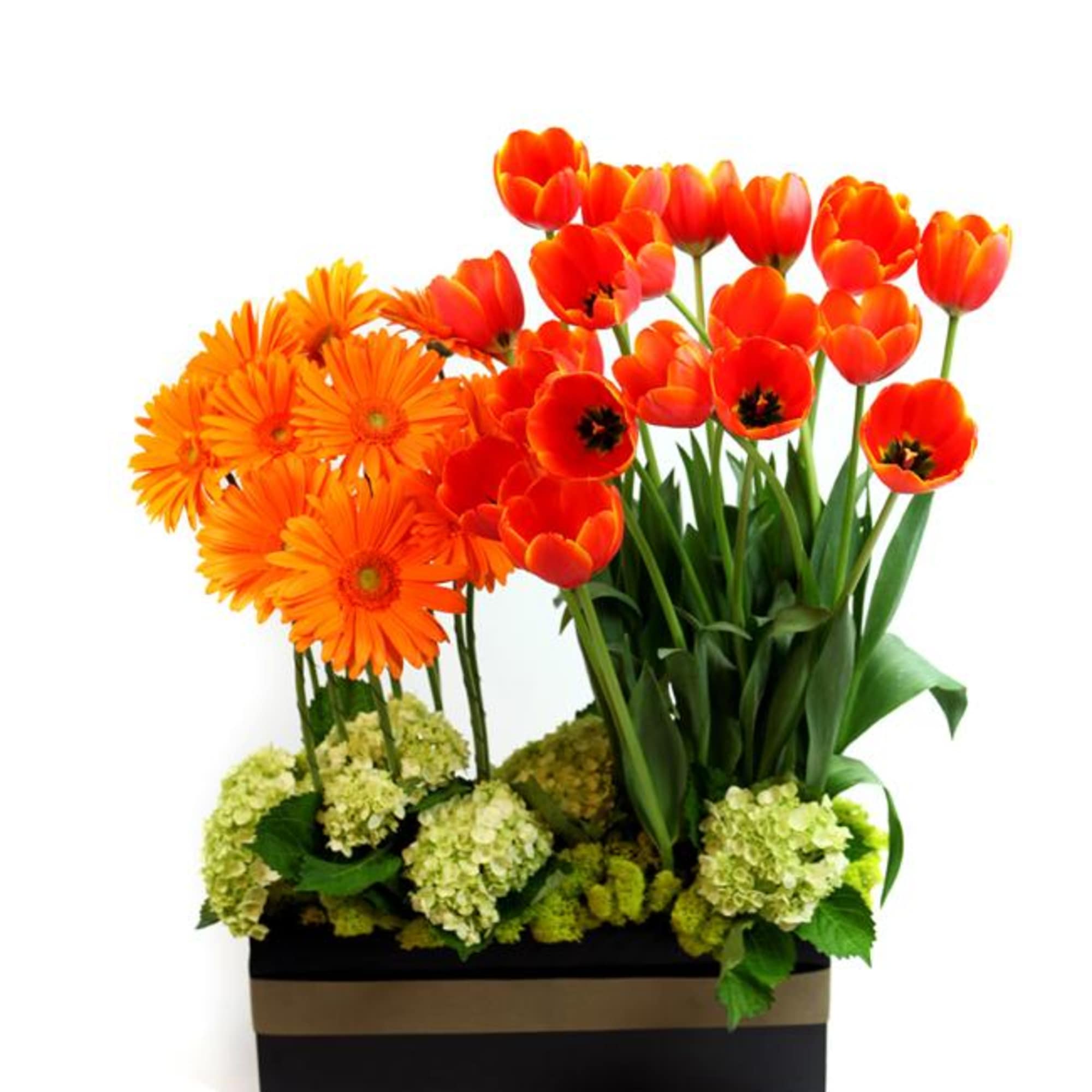This vibrant arrangement is filled with colorful blooms including orange Gerber daisies