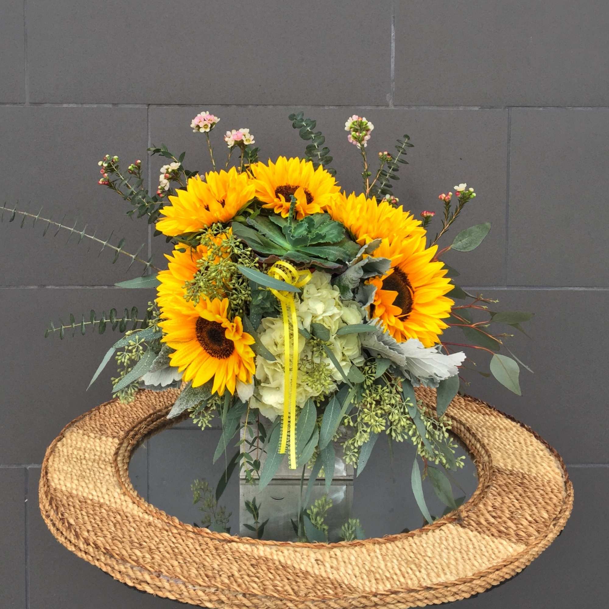 Sunshine design including sunflowers, succulent and accents in a wood box.
STANDARD: FIRST
