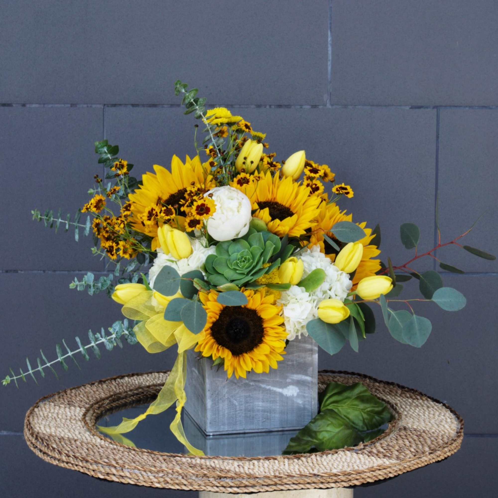 Sunshine design including sunflowers, succulent and accents in a wood box.
STANDARD: FIRST