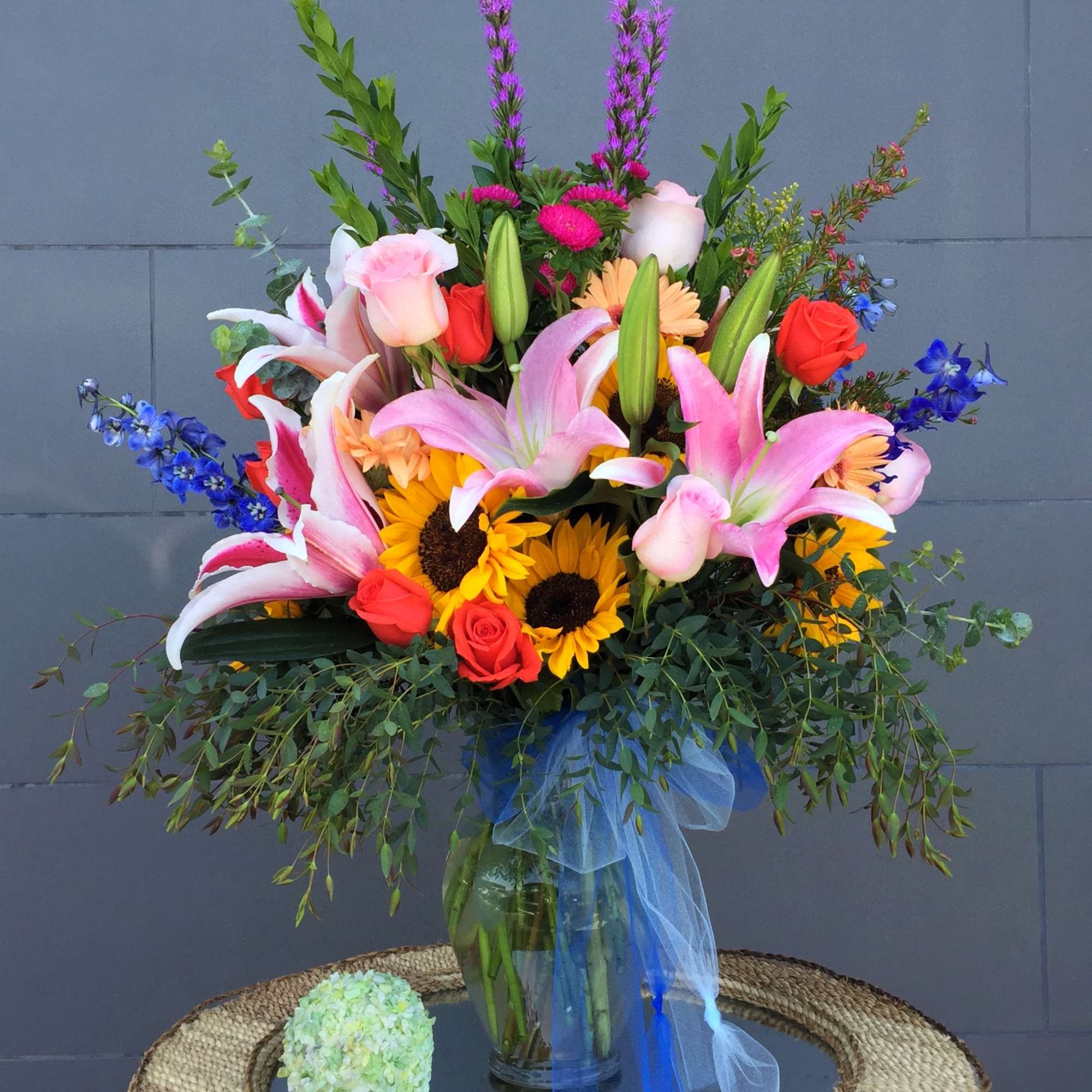 Beautiful blooms of sunflower, rose, lily, hydrangea... and accents in a tall