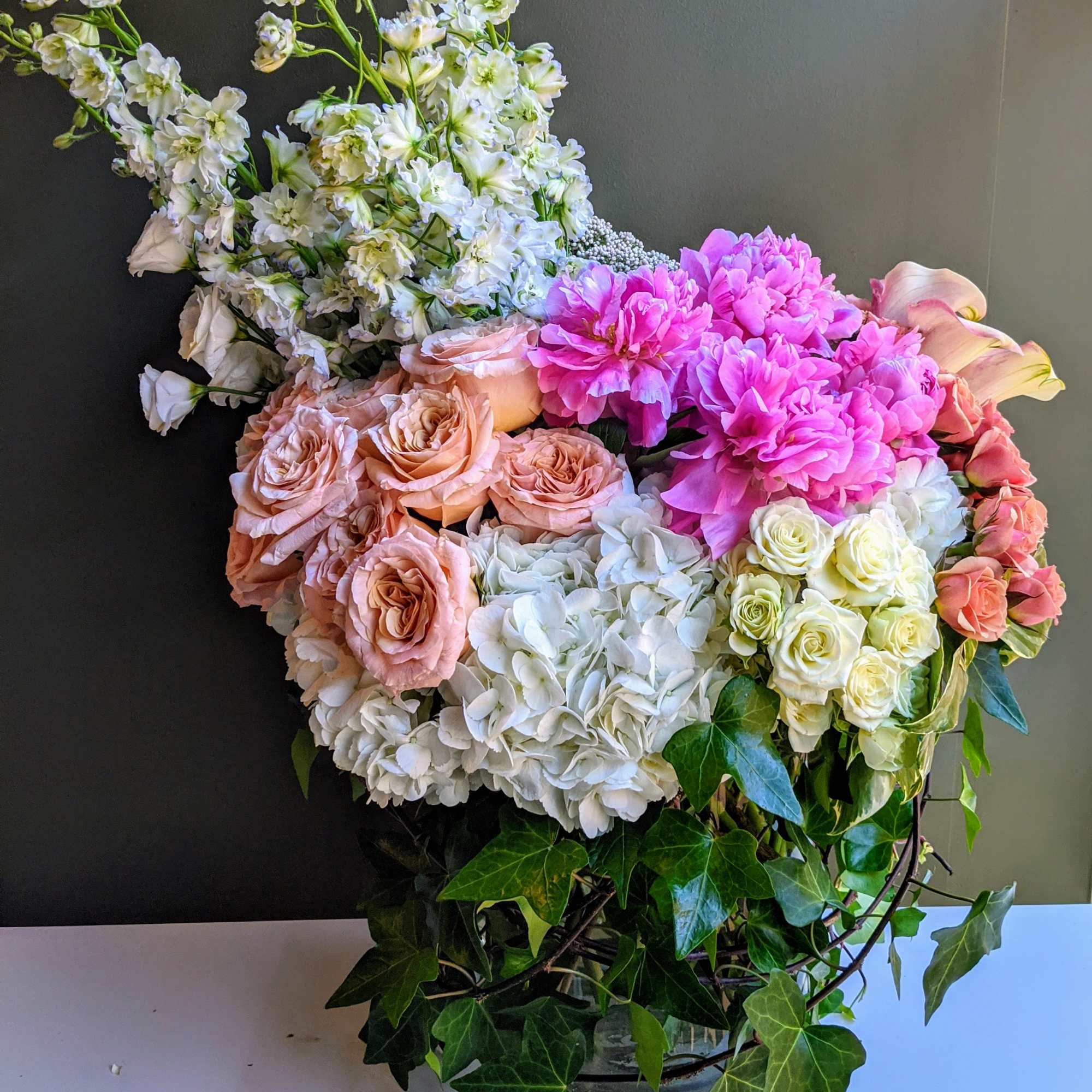 This Oversized arrangement features all the summer favorites in whites and peachy