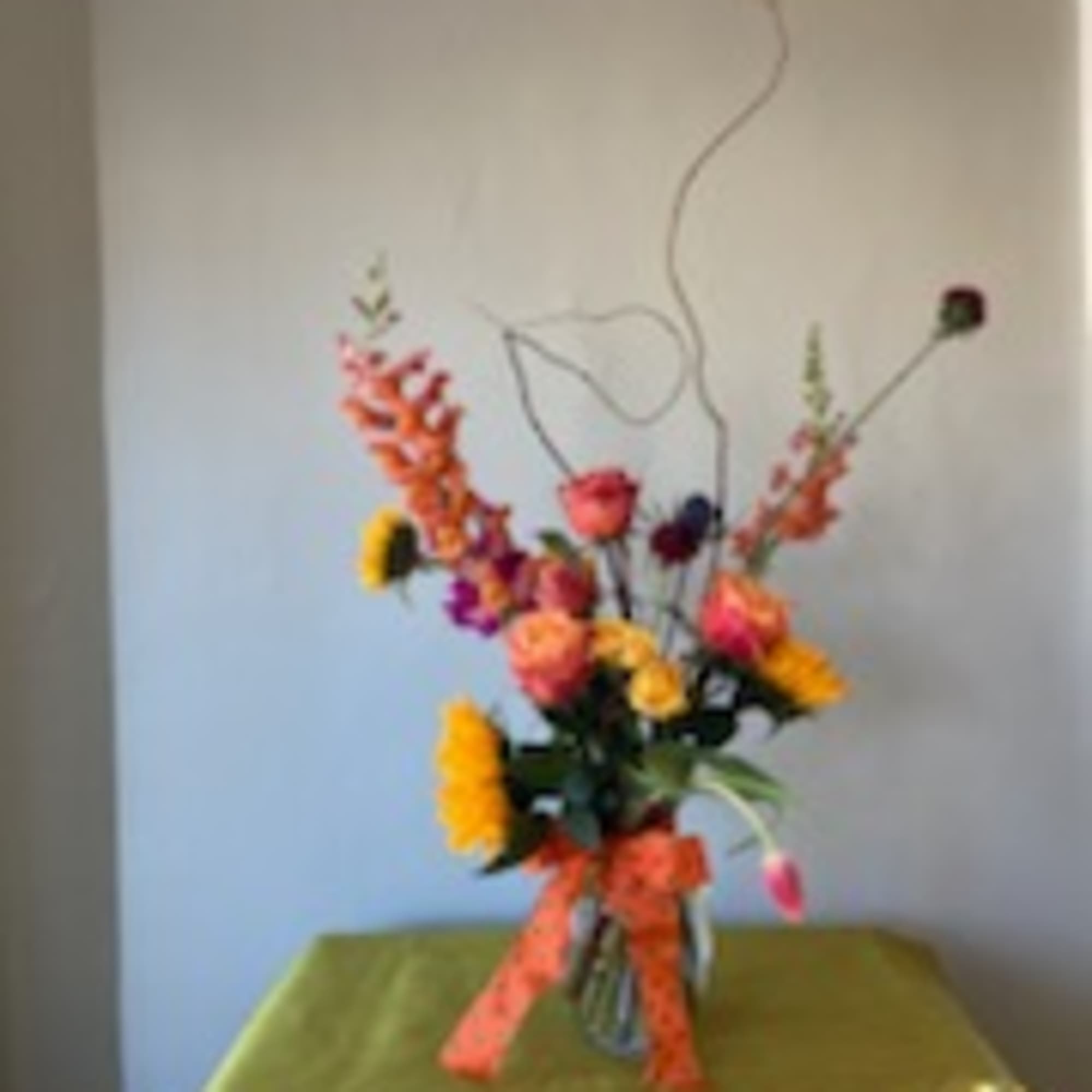 A one of a kind seasonal flower arrangement beautifully designed using in