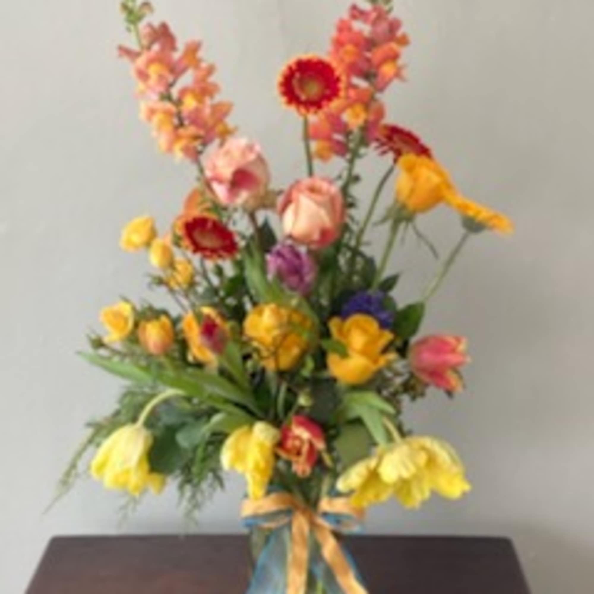 A one of a kind seasonal flower arrangement beautifully designed using in