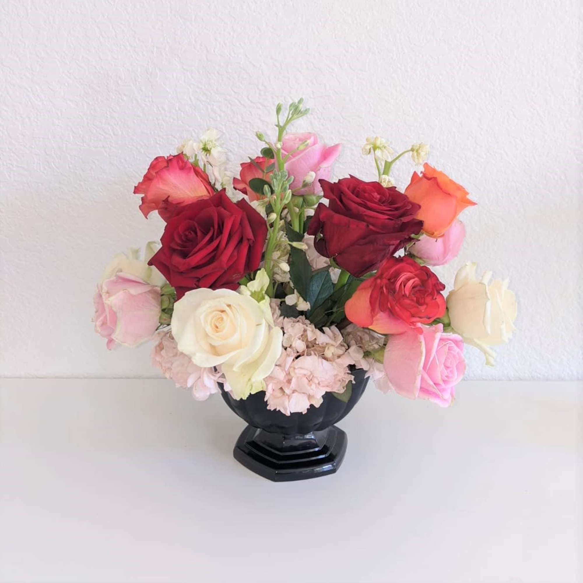 A very delightful cup of different roses and hydrangeas. Perfect for a