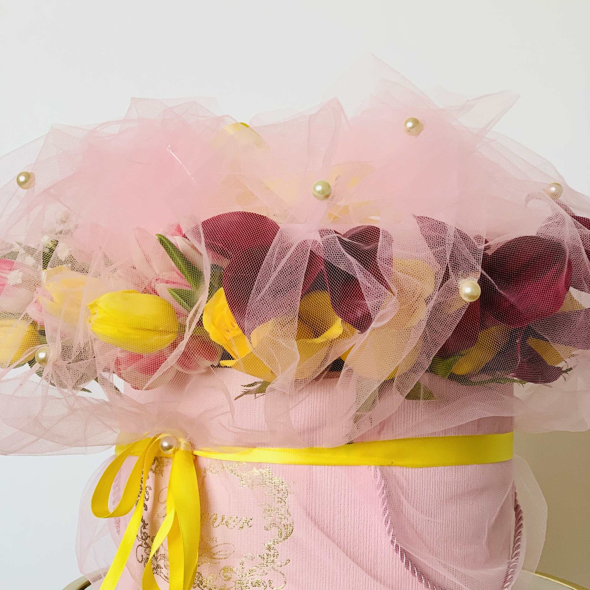 A box of flora arrangement wrapped in a tulle