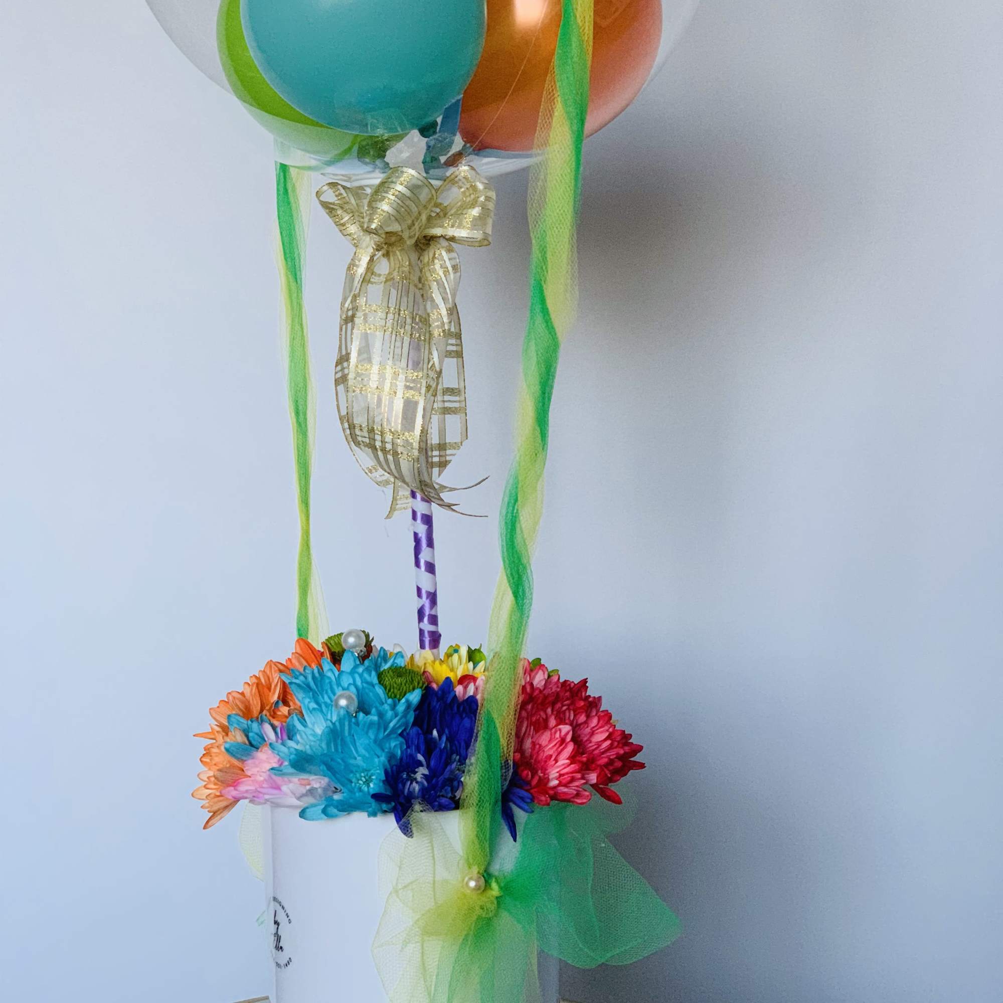 Tall mixed floral arrangement and a bubble balloon, colors may be requested