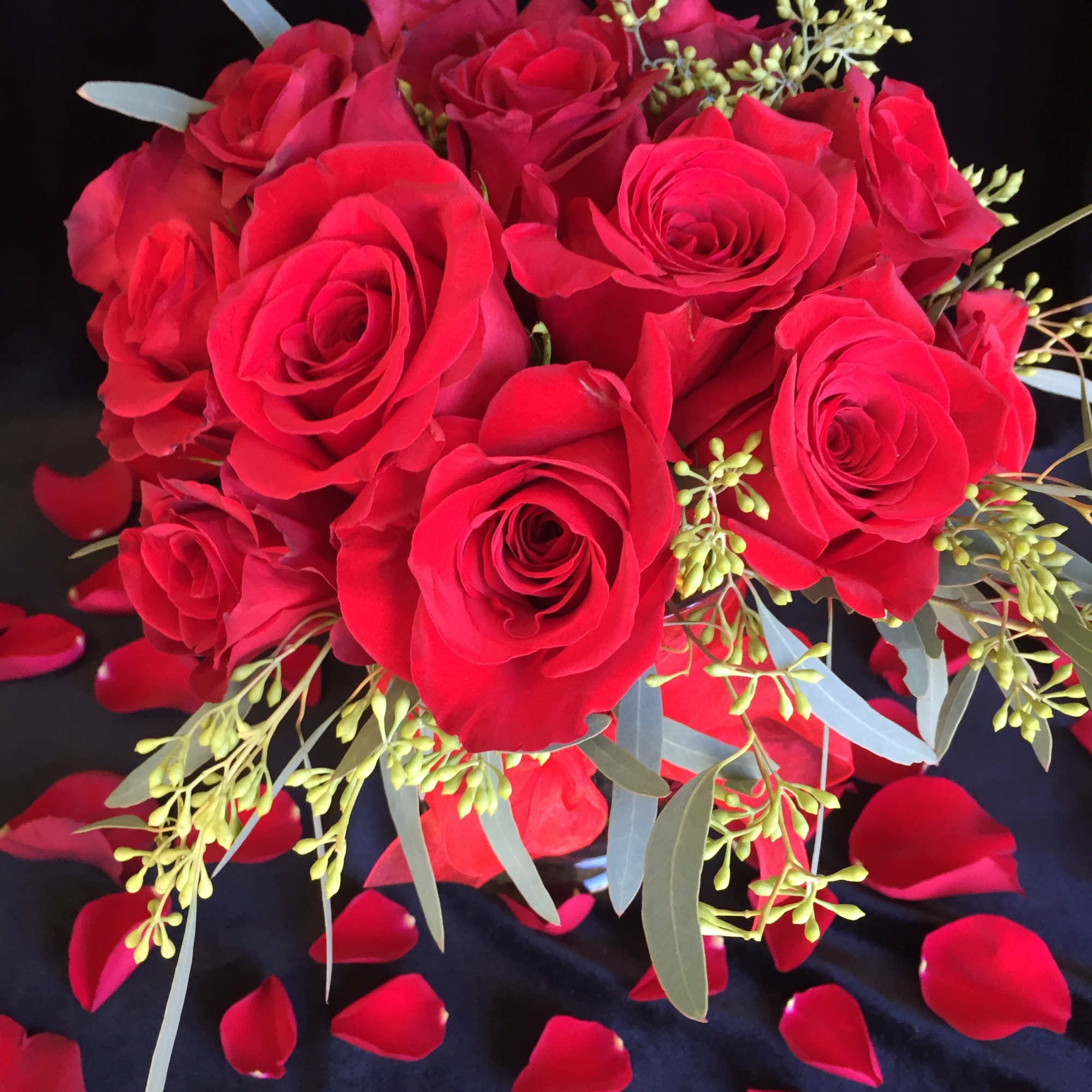 Red roses styled low and lush with accents of greenery. 

* it&#039;s